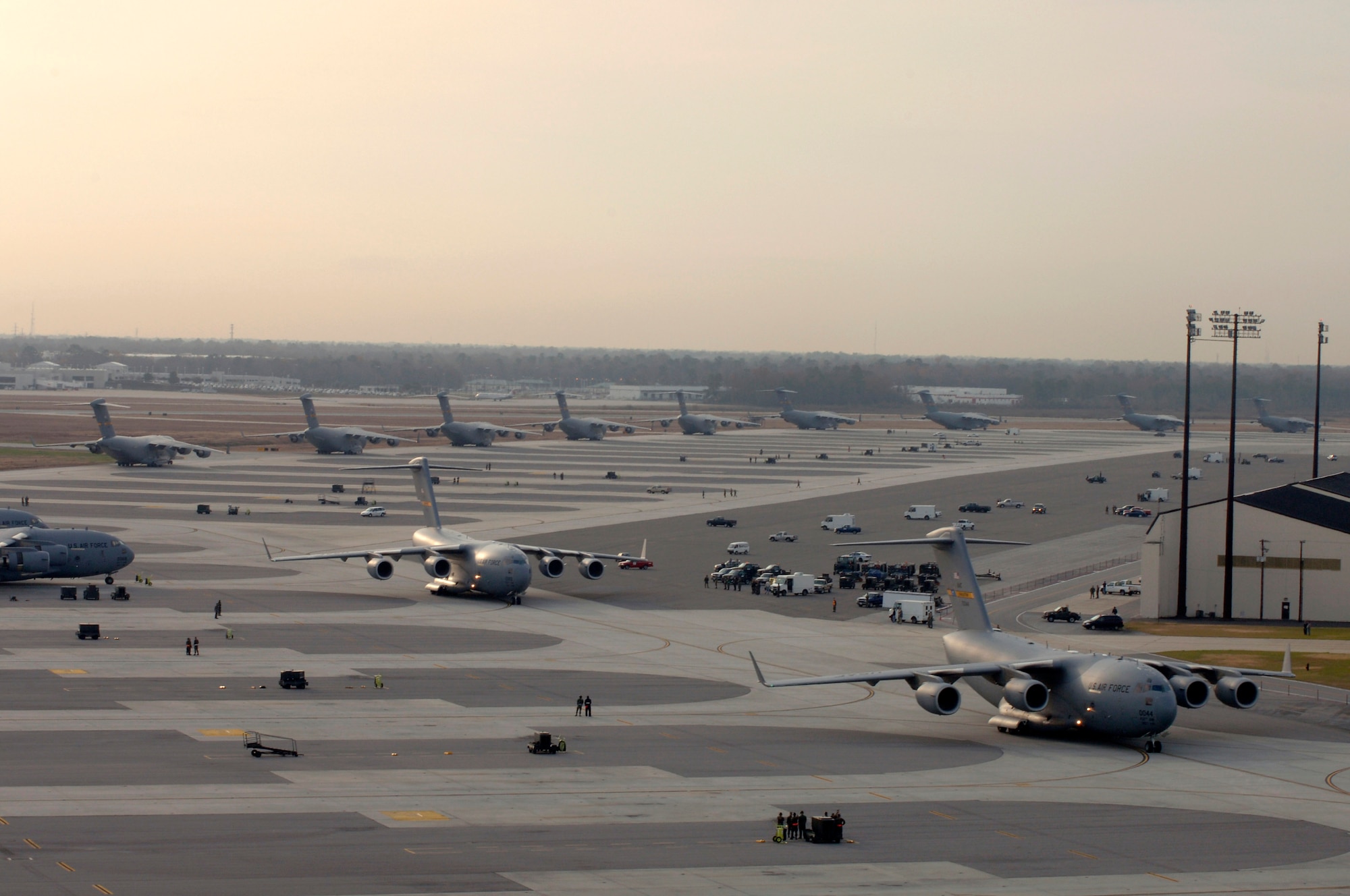 A line of C-17 Globemaster III's prepare to taxi Dec. 21 at Charleston Air Force Base, S.C. The C-17 is capable of rapid, strategic delivery of troops and all types of cargo. The design of the aircraft allows it to operate on small, austere airfields. It can take off and land on runways as short as 3,500 feet and 90 feet wide. (U.S. Air Force photo/Staff Sgt. April Quintanilla) 

