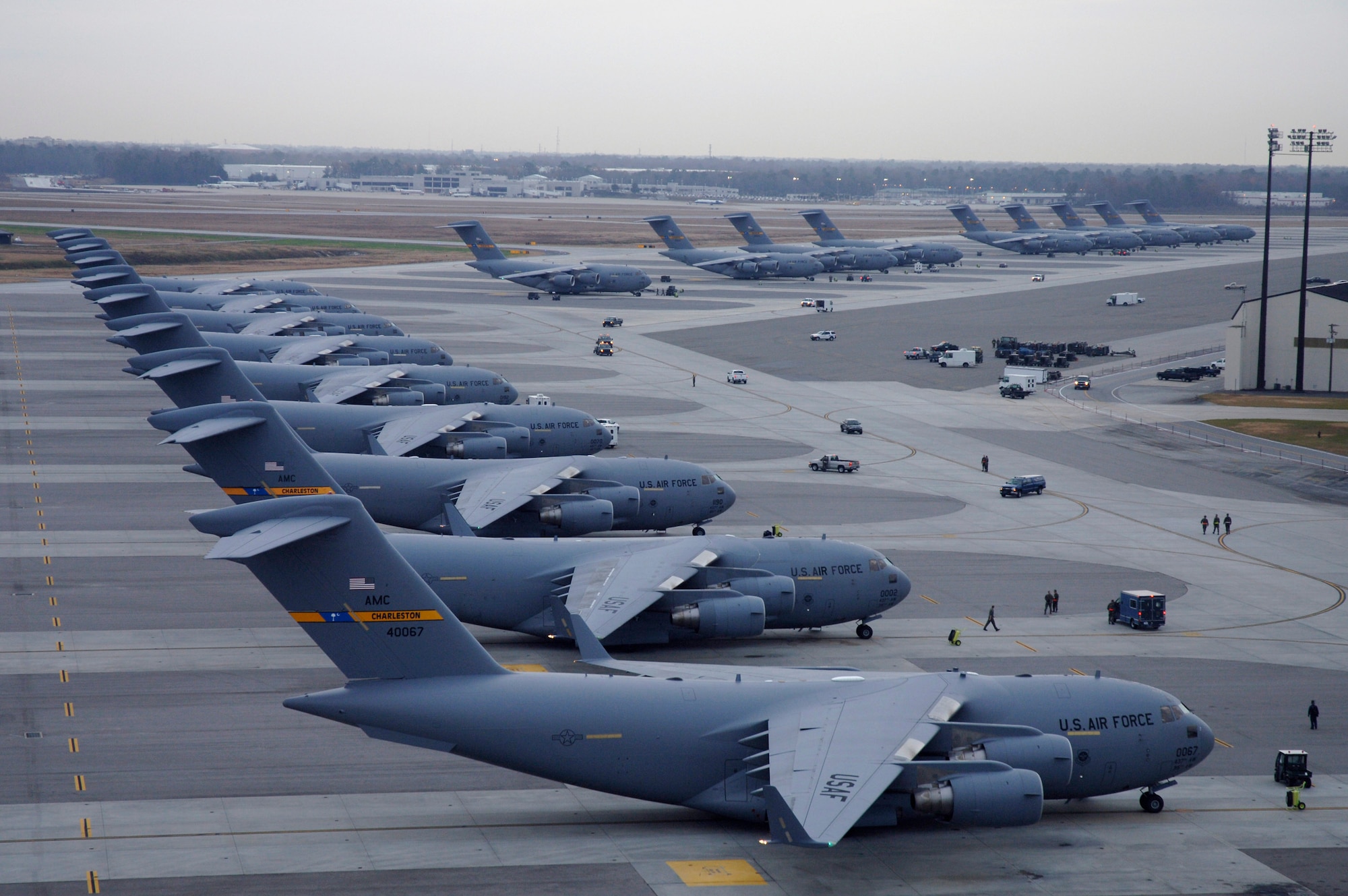 A line of C-17 Globemaster III's are parked on the runway Dec. 21 at Charleston Air Force Base, S.C. The C-17 is capable of rapid, strategic delivery of troops and all types of cargo. The design of the aircraft allows it to operate on small, austere airfields. It can take off and land on runways as short as 3,500 feet and 90 feet wide. (U.S. Air Force photo/Staff Sgt. April Quintanilla) 
