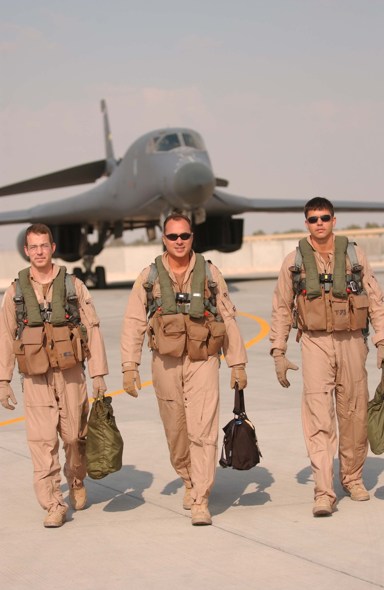 After a 12-hour nighttime close-air support mission over Afghanistan recently, Capt. Craig Morrison, Maj. Mike Jason and Capt. David Grasso walk from a B-1B Lancer. The weapon systems officer, aircraft commander and co-pilot are assigned to the 37th Expeditionary Bomb Squadron, part of the 379th Air Expeditionary Wing in Southwest Asia. (U.S. Air Force photo/Ricky Best) 