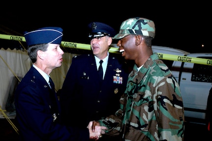 Brig. Gen. Darrell Jones, then the 37th Training Wing commander, wishes Airman Basic Garland Javeureous from the 326th Training Squadron a Happy Holiday during the Basic Military Training Christmas Eve Extravaganza Dec. 24, 2006, at Lackland Air Force Base, Texas. (USAF photo by Staff Sgt. Tim Russer)