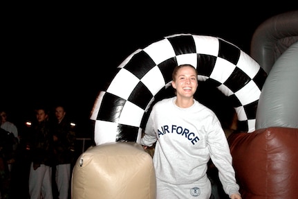 Airman Basic Amber Hewetson from the 323rd Training Squadron exits an inflatable maze race victoriously during the Basic Military Training Christmas Eve Extravaganza on Dec. 24 at Lackland Air Force Base, Texas. (USAF photo by Staff Sgt. Tim Russer)