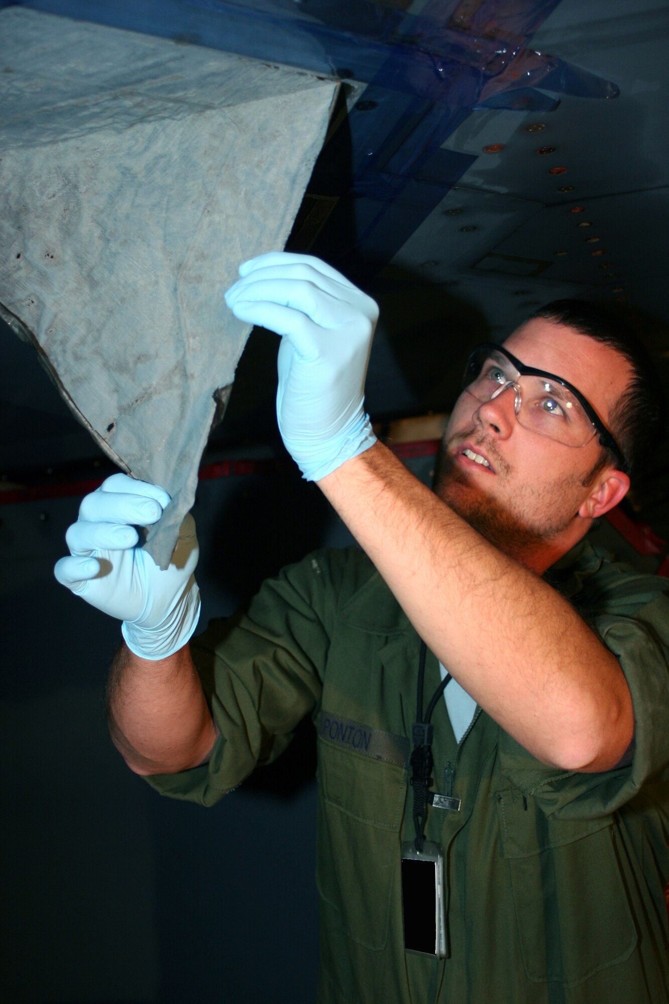 Kevin Poton, Department of Defense civilian with the 509th Maintenance Squadron, removes a sheet of residual tape to repair the skin of the B-2. Constant repairs and touch-ups are needed to ensure the B-2 is able to successfully complete its stealth mission. 
