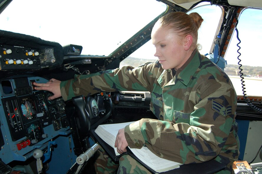 Senior Airman Jessica Wheat, an electrician and environmental specialist on the C-5A at Lackland AFB's Kelly Field. Airman Wheat, a reservist here, is performing an operational check of the master caution system after she replaced it ensuring that each warning and indicator light was working properly. (U.S. Air Force photo/Senior Master Sgt. Troy Pearson)