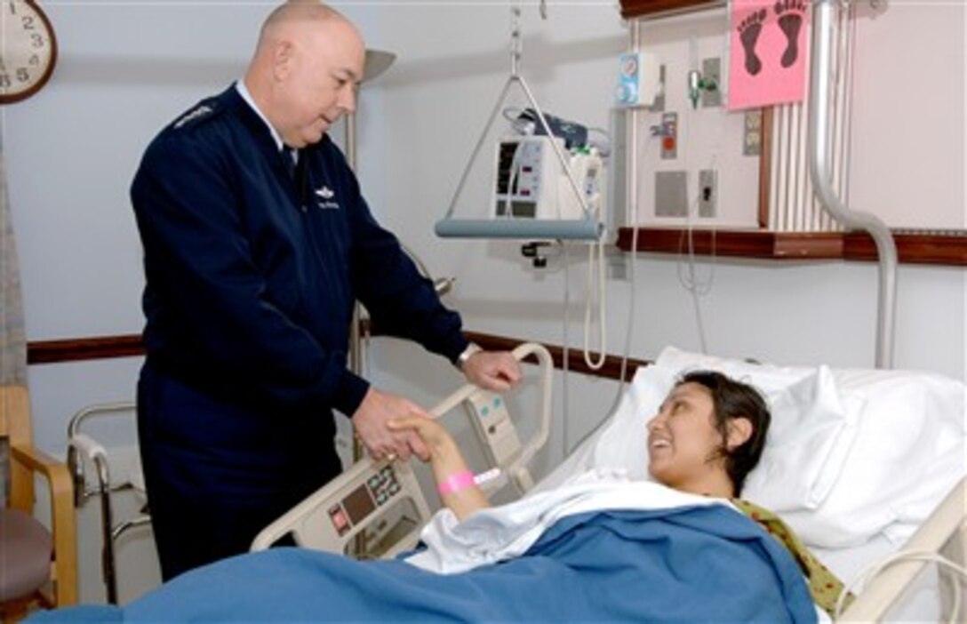 U.S. Air Force Chief of Staff T. Michael Moseley offers his best wishes to Staff Sgt. Aime Gaona during a visit to Malcolm Grow Medical Center at Andrews Air Force Base, Md., Dec. 27, 2006. Gaona arrived at Malcolm Grow Dec. 22 after being shot in the right thigh by a sniper just four days earlier in Iraq.