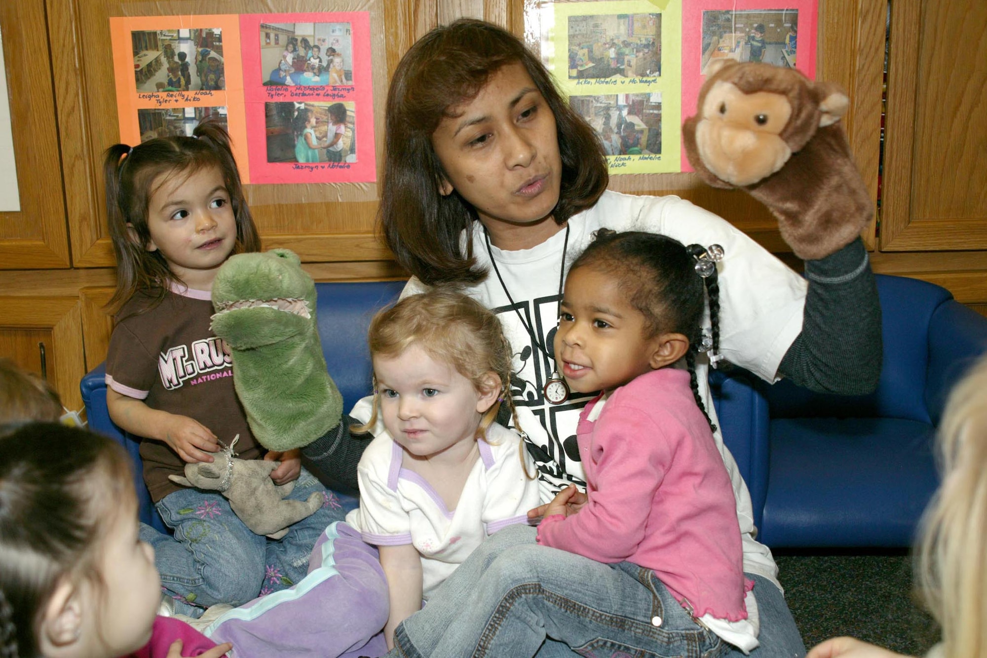 SHAW AIR FORCE BASE, S.C. -- Vangie Wathen, 20th Services Squadron child development program assistant, sings a tale to children Dec. 28 at the child development center. (U.S. Air Force photo/Tarsha Storey)