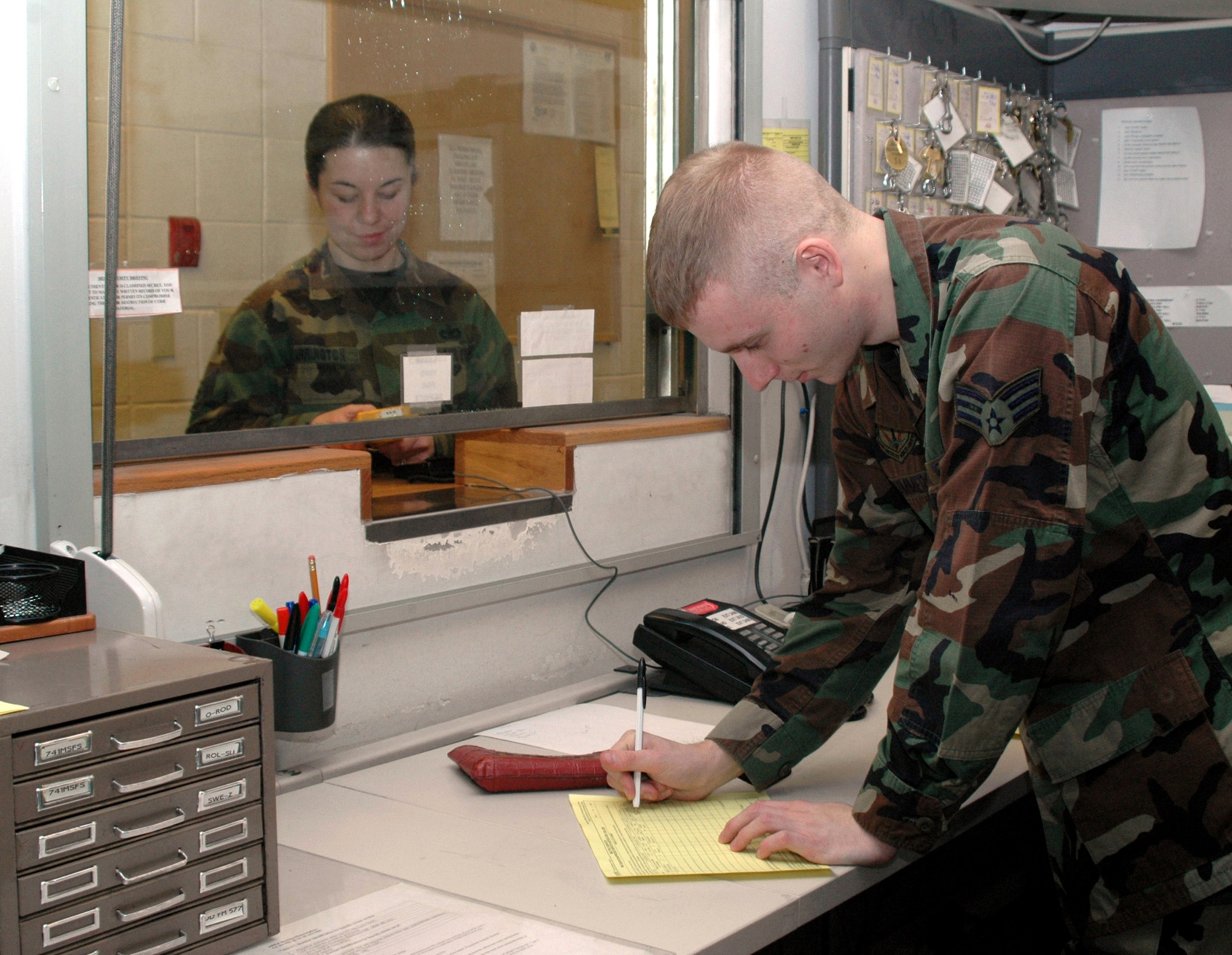 Senior Airman Ryan Summers fills out a form for the release of equipment. Airman Summers is a keys and codes controller for the 341st Security Support Squadron at Malmstrom Air Force Base, Mont. and will be working on the job this holiday season.  While he says the job is tedious at times, Airman Summers is proud to serve his country. (U.S. Air Force photo/Airman Emerald Ralston)


