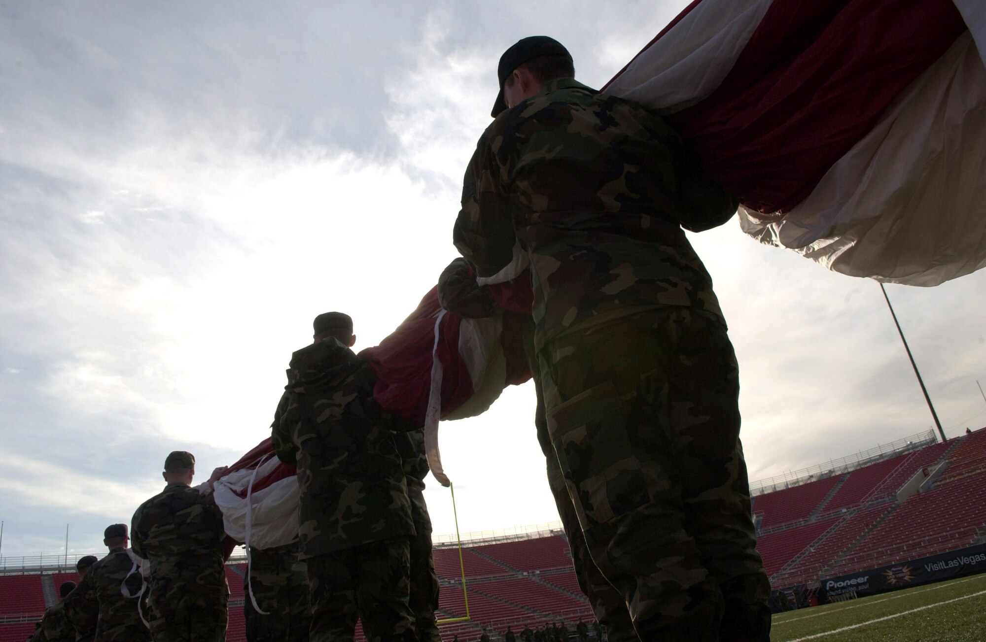 250 Airmen practice folding an American flag prior to presenting the 100-yard-by-50-yard Old Glory during the national anthem before the Las Vegas Bowl. The nationally televised football bowl game Dec. 21 featured Brigham Young University and University of Oregon at Sam Boyd Stadium in Las Vegas. The BYU beat Oregon 38-8. The Airmen are from Nellis AFB, Nev. (U.S. Air Force photo/Master Sgt. Kevin J. Gruenwald) 
