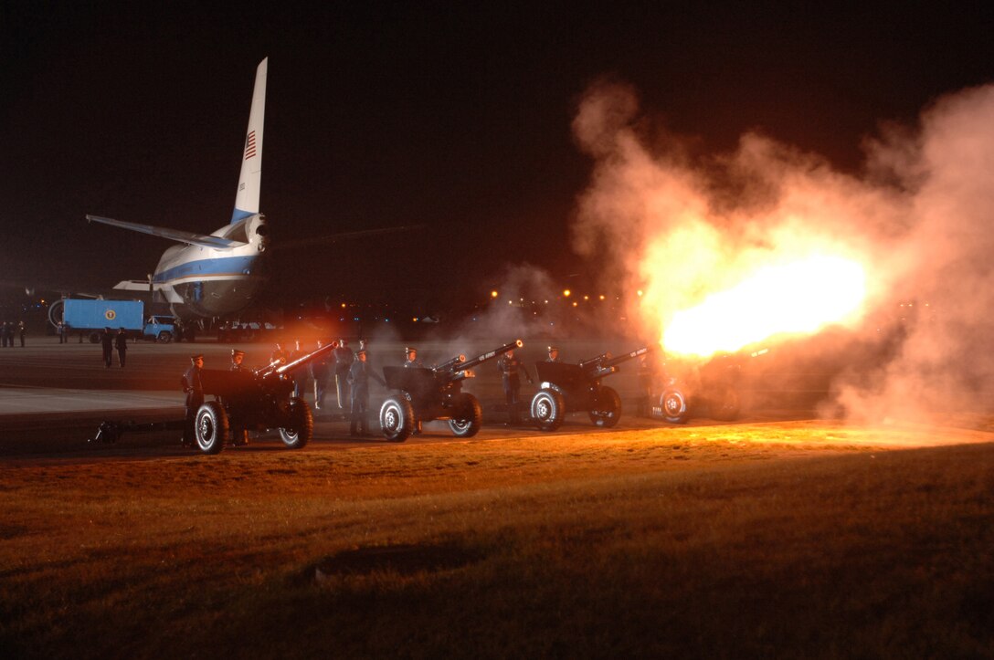 Members of the Presidential Salute Gun Platoon, 3rd U.S. Infantry Regiment perform a 21-gun salute to pay respect to Gerald R. Ford as he arrives at Andrews Air Force Base, Md., Dec. 30, 2006, as part of the national farewell funeral procession honoring the former commander in chief.