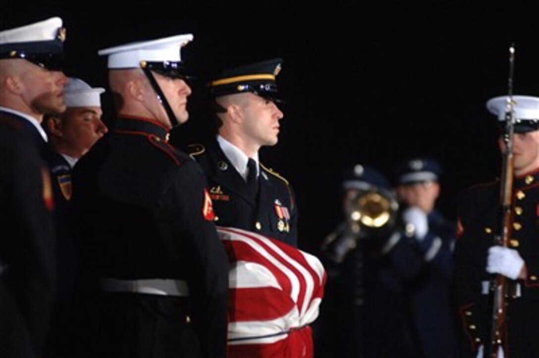 The casket of Gerald R. Ford is carried by the Ceremonial Honor Guard at Andrews Air Force Base, Md., Dec. 30, 2006, as part of the national farewell funeral procession honoring the former Commander in Chief.