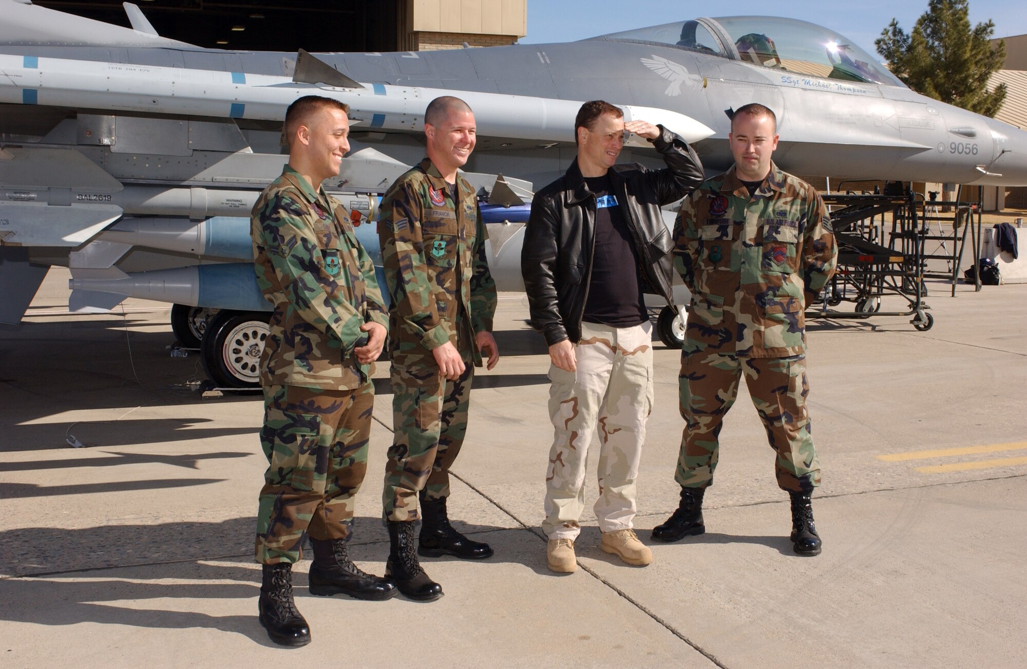 LUKE AIR FORCE BASE, Ariz. -- Gary Sinise looks at F-16 Fighting Falcons on the flightline here with Airman 1st Class Bryan Strole (left), Senior Airman Ian Franck and Staff Sgt. Michael Thompson (right). Mr. Sinise and his band performed here Jan. 28. The Airmen are crew chiefs with the 756th Aircraft Maintenance Squadron. (U.S. Air Force photo) 
