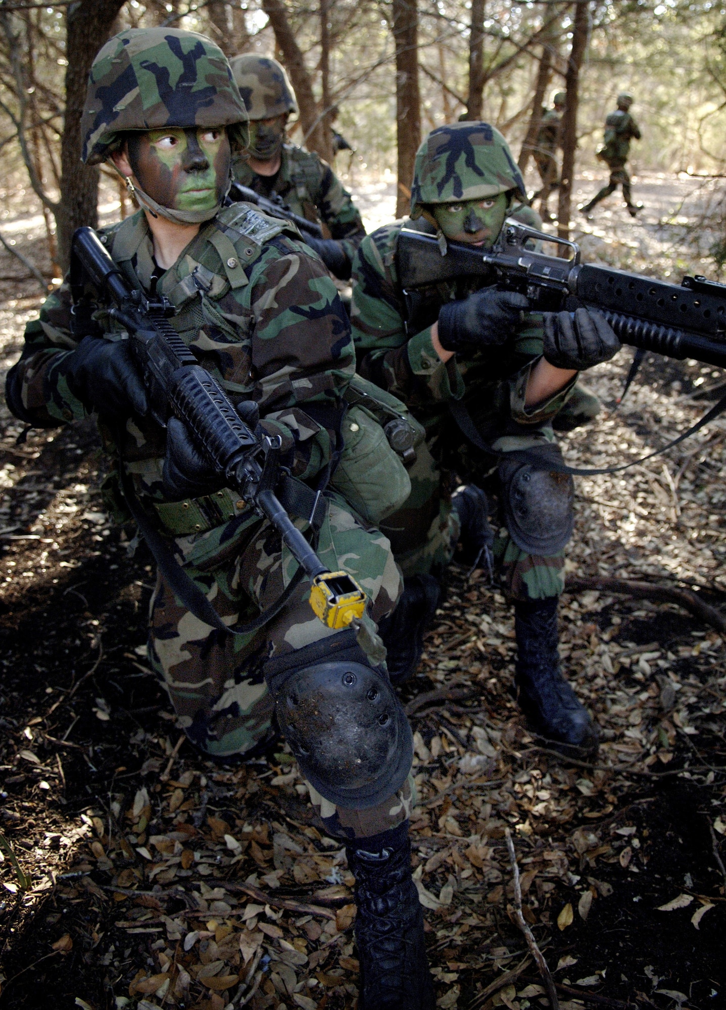LACKLAND AIR FORCE BASE, Texas (AFPN) -- (Front to back) Airmen Heather Simpson, Wayne Stickles and Steve Schepel provide cover while the rest of the fire teams run to the rendezvous point during security forces technical training here Jan. 30. This three-week portion of their training familiarizes Airmen with concepts and tactics used in basic military operations in urban terrain. (U.S. Air Force photo by Tech. Sgt. Larry A. Simmons)