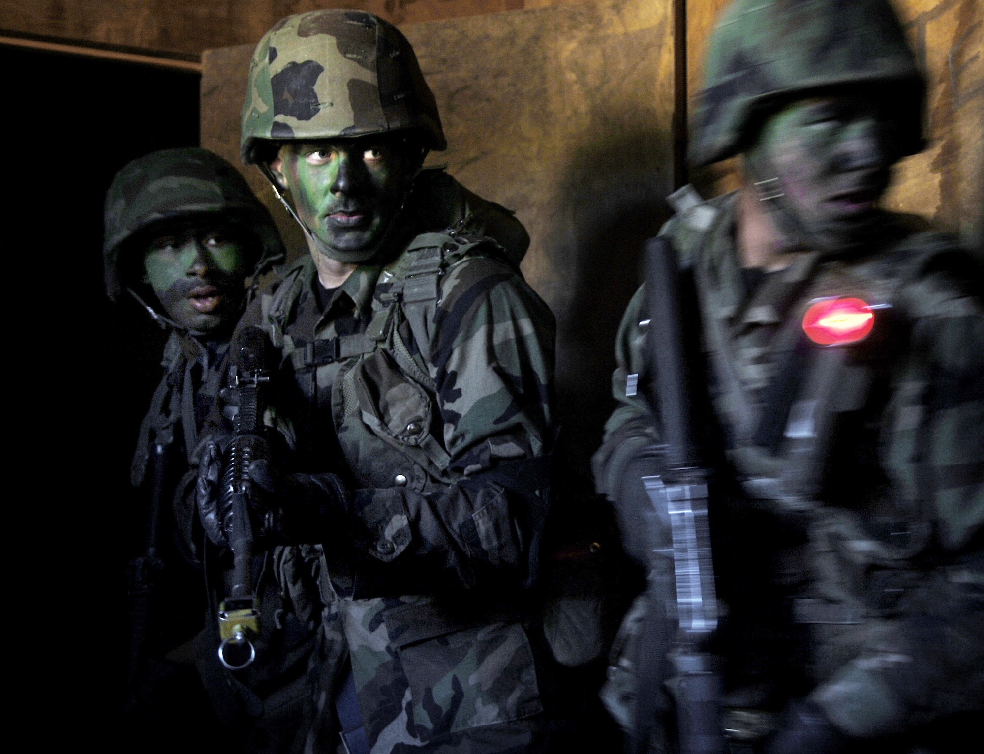 LACKLAND AIR FORCE BASE, Texas (AFPN) -- (From left) Airmen Jason Sumlin, Steven Schepel and Wayne Stickles use proper room-clearing tactics during security forces technical training here Jan. 30.  This three-week portion of their training familiarizes Airmen with concepts and tactics used in basic military operations in urban terrain. (U.S. Air Force photo by Tech. Sgt. Larry A. Simmons)