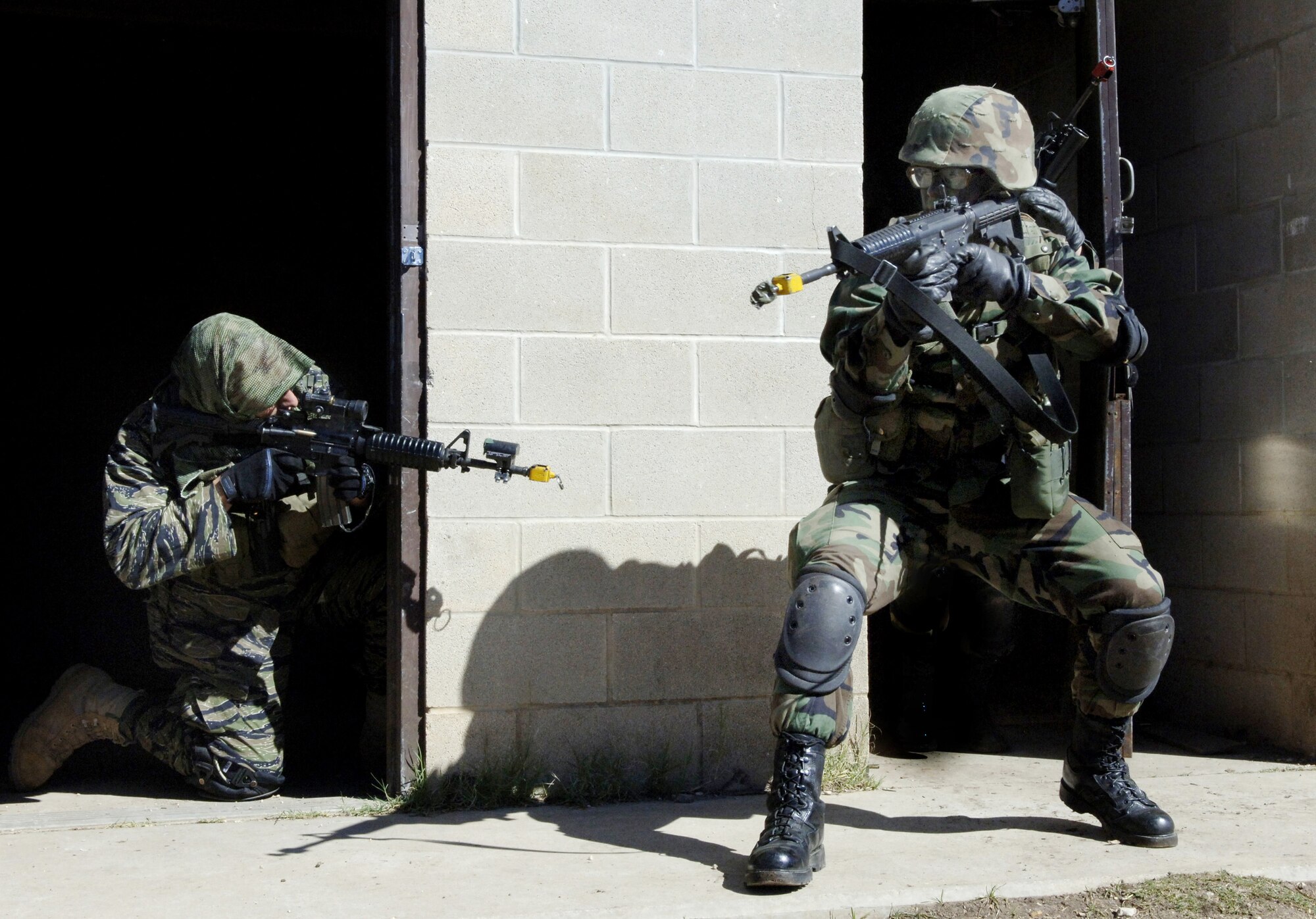 LACKLAND AIR FORCE BASE, Texas (AFPN) -- Airman 1st Class Tremayne Williams (right) reacts to an instructor playing the role of the opposition force during security forces technical training here Jan. 30.  This three-week portion of their training familiarizes Airmen with concepts and tactics used in basic military operations in urban terrain.  (U.S. Air Force photo by Tech. Sgt. Larry A. Simmons)
