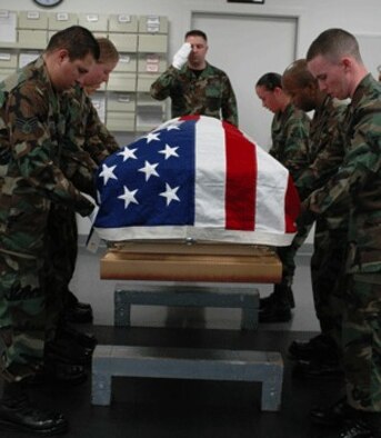 Staff Sgt. Ryan Phillips, honor guard member from the 349th Aeromedical Staging Squadron, salutes the flag during a routine honor guard practice. The 161-member honor guard team performs at funeral ceremonies, in parades and serves as color guards. The team also trains Travis Team members in proper military protocol for retirement ceremonies.