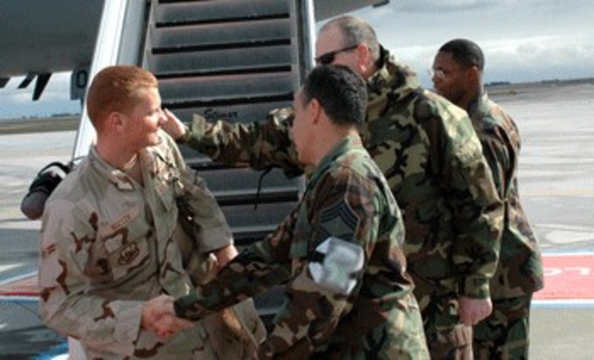 Airman 1st Class Clint Mullen receives a welcome from his leadership after a 120-day deployment in support of Operations Iraqi and Enduring Freedom.