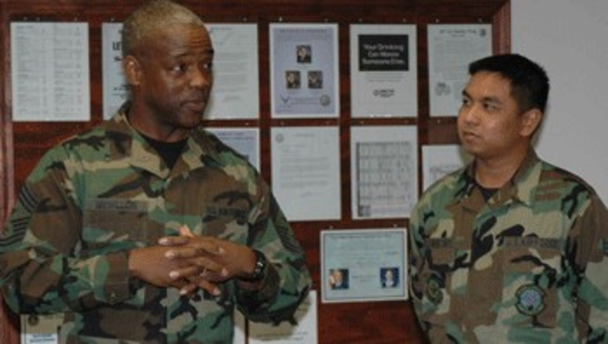 Chief Master Sgt. Brye McMillon, 60th Air Mobility Wing command chief, speaks to Senior Airman Russell Dela Montanye, 60th Logistics Readiness Squadron. Chief McMillon visited Bldg. 552 to present coins to the Airmen who helped move the Airman’s Attic.
