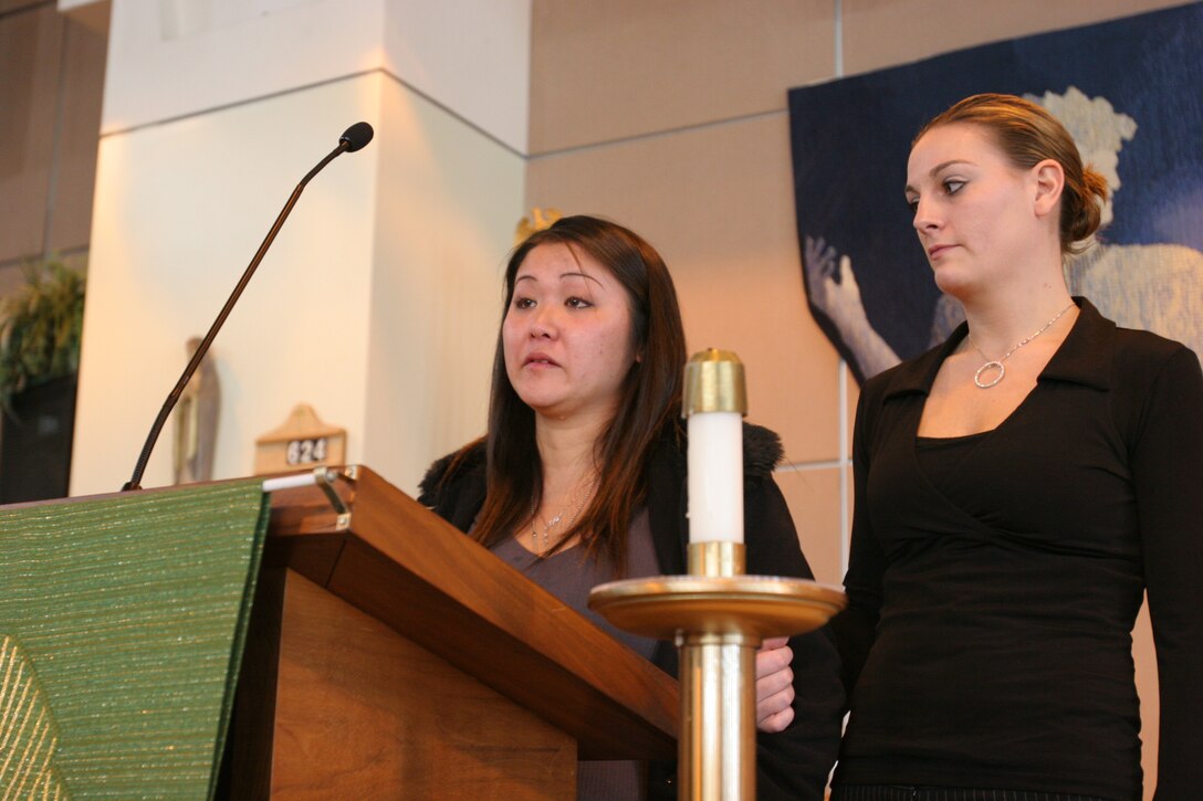 050131-M-7082F-003 CAMP PENDLETON, Calif. -- Rebecca Huff, accompanied by  Kelly M. Adamson, recalls memories of her husband Cpl. Justin L. Huff at a memorial service in his honor. Huff's body was found Jan. 13 buried in North Carolina. Huff is survived by his his wife Rebecca, their unborn child and his parents Blaine and Theresa. Ramirez is the intelligence chief for Brigade Service Support Group- 1, 1st Marine Logistics Group. Adamson is Justin's older sister. (Official U.S. Marine Corps photo by Lance Cpl. Patrick J. Floto)(released)