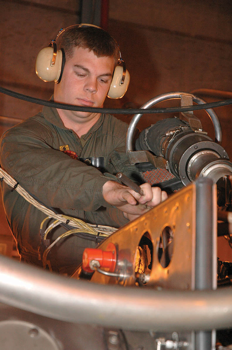 Sgt. John D. Park IV, Marine Aviation Logistics Squadron 13 test cell operator and native of Sacramento, Calif., tightens down a loose bolt on an F402-RR-408B AV-8B Harrier engine Feb. 1 at the T-10 Test Cell, Building 310 here. The test cell is used to ensure that the Harrier engines are safe for use after maintenance is completed on them. The engines are tested for a variety of factors, such as thrust, vibration, acceleration and heat.