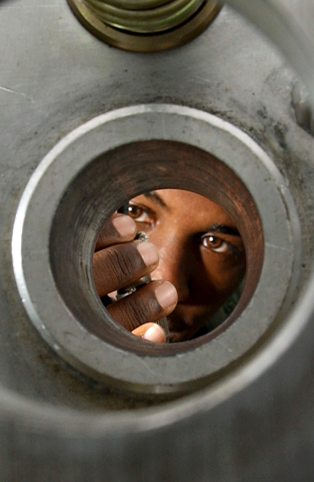 MACDILL AIR FORCE BASE, Fla. (AFPN) -- Senior Airman Wayne Howell does a preventive maintenance inspection here on the tool mount of a remote operated neutralization system Jan. 30. The system is used to retrieve explosive devices.  Airman Howell is an explosive ordnance disposal technician with the 6th Civil Engineer Squadron. (U.S. Air Force photo by Airman 1st Class Bradley A. Lail)