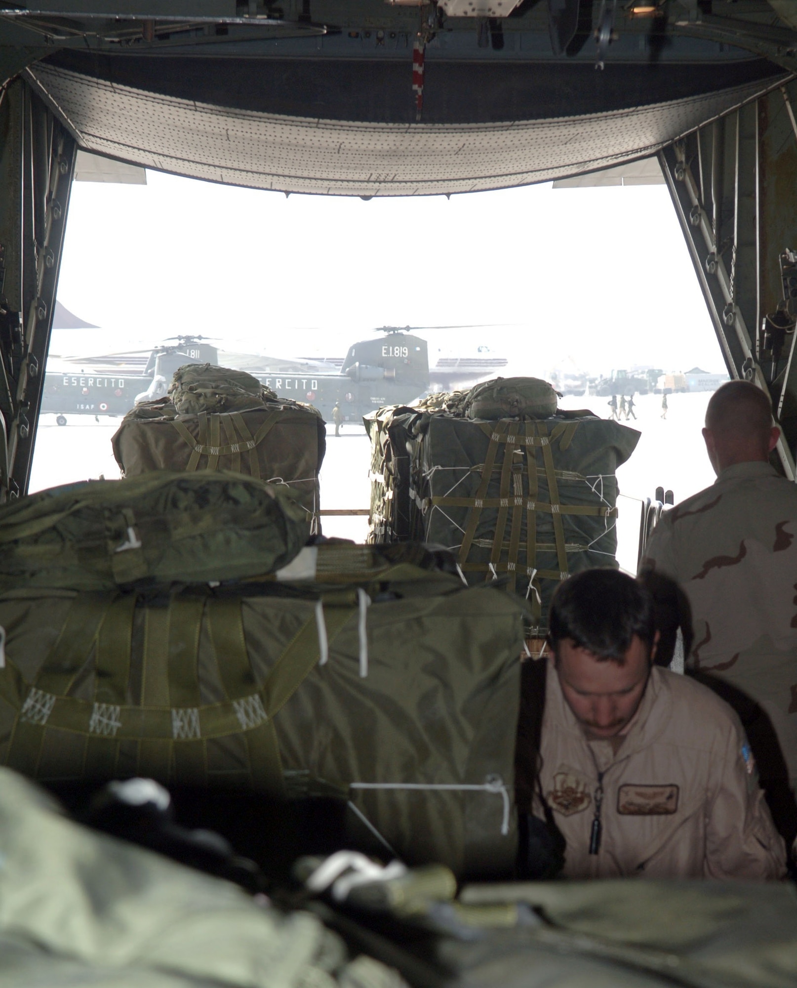 BAGRAM AIR BASE, Afghanistan (AFPN) -- Staff Sgt. Trenton Lloyd loads an 800-pound pallet of firewood onto a C-130 Hercules for a humanitarian airdrop in southern Afghanistan Jan. 24. Sergeant Trenton is a C-130 loadmaster with the 774th Expeditionary Airlift Squadron. C-130s from the 774th EAS have delivered medical supplies, blankets, small heaters, firewood, blankets and food to help Afghan civilians in remote regions get through the winter. Sergeant Lloyd is with the Air National Guard's 153rd Airlift Wing at Cheyenne, Wyo. (U.S. Air Force photo by Staff Sgt. Jennifer Redente)