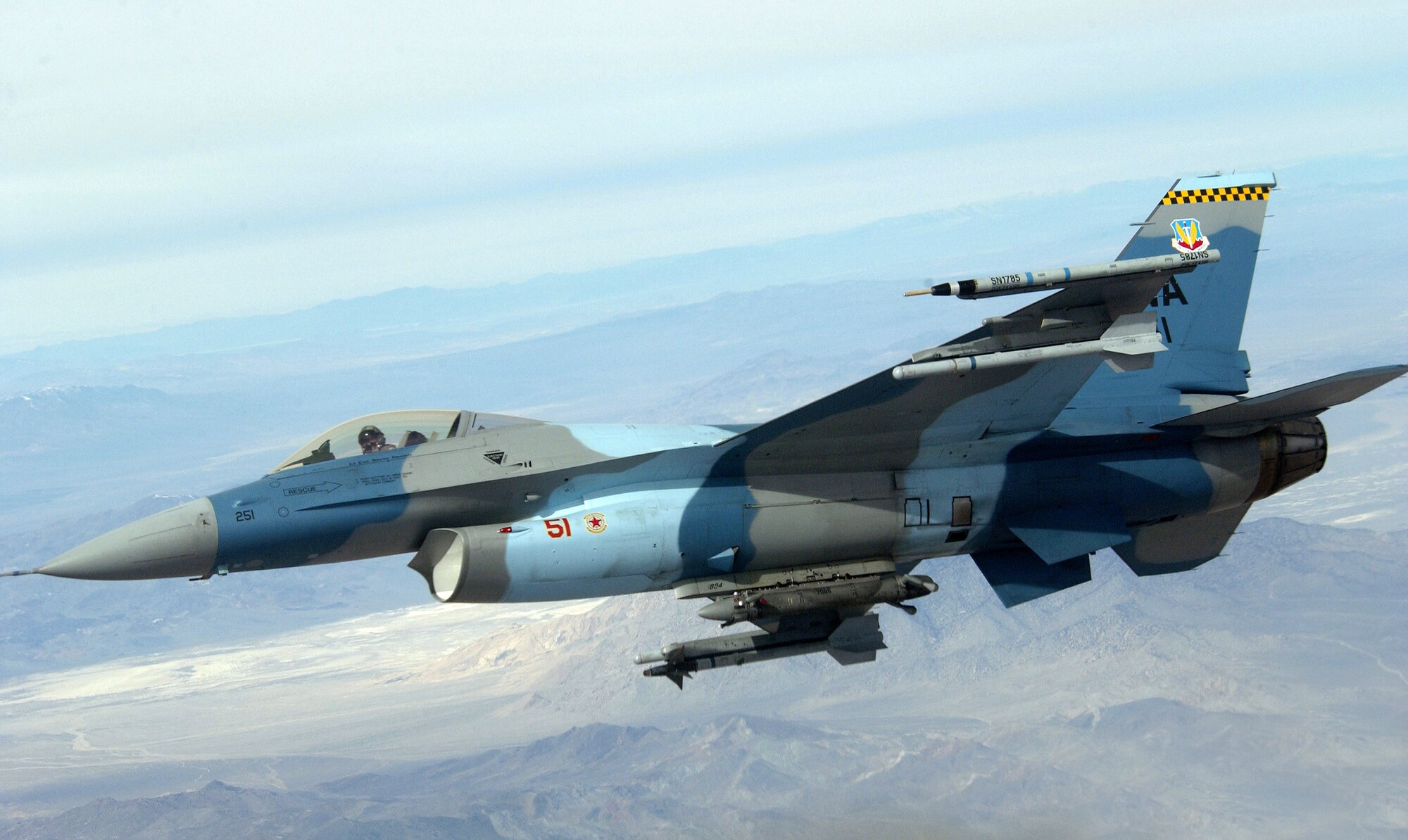 NELLIS AIR FORCE BASE, Nev. (AFPN) -- An F-16 Fighting Falcon heads out to a range Jan. 31 during Red Flag 06-1 being held here Jan. 21 through Feb. 18. Red Flag tests aircrews' war-fighting skills in realistic combat situations. Aircraft fly missions day and night at the nearby Nevada Test and Training Range simulating an air war. Along with the Air Force, units from the Army, Navy, Marine Corps, United Kingdom and Australia are participating. The F-16 is with the 64th Aggressor Squadron. (U.S. Air Force photo by Master Sgt. Kevin J. Gruenwald)
