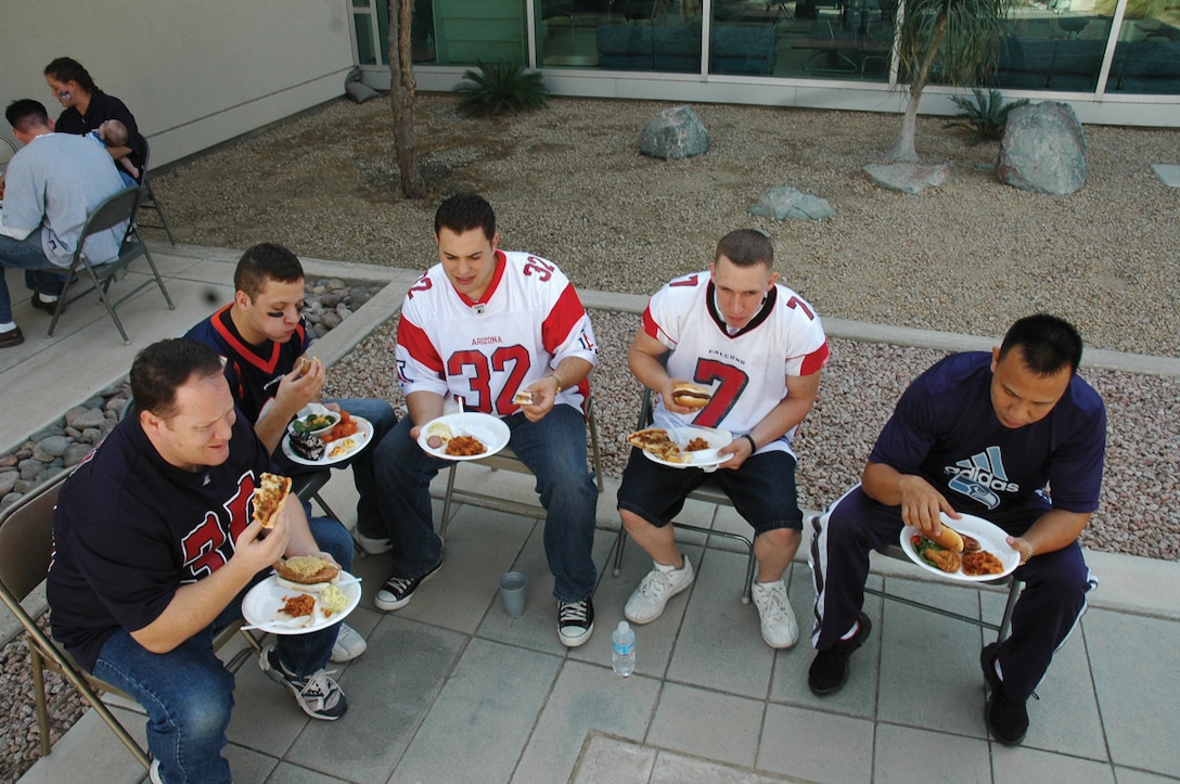A group of sailors eat their food at the Branch Medical Clinic?s 3rd Annual Super Bowl Tailgate Party Feb. 2 at the BMC courtyard here.