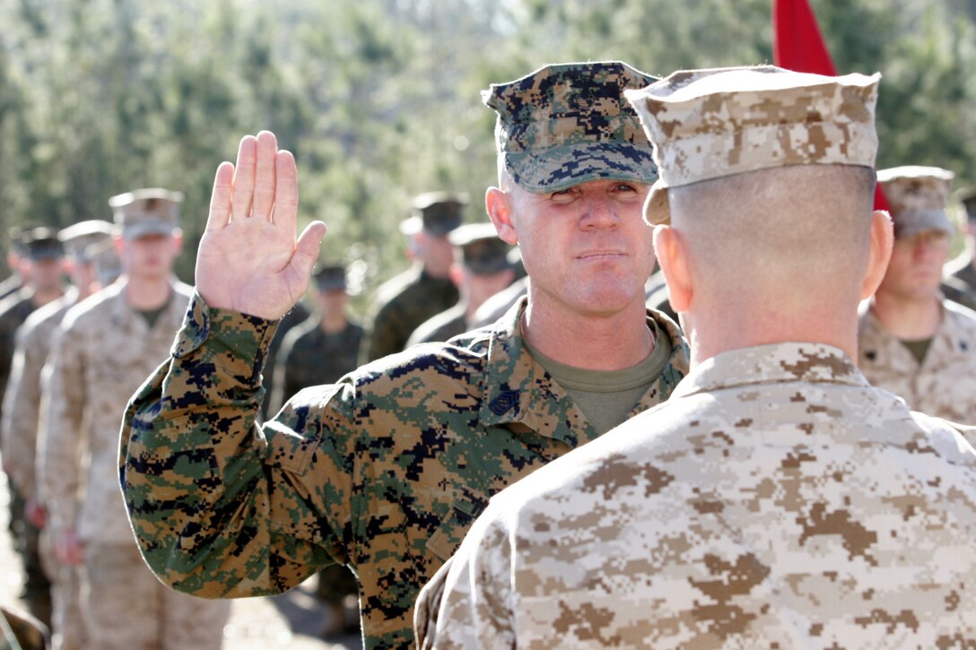 Marines from Battalion Landing Team 1st Battalion, 4th Marine Regiment, pay their respects to fallen comrades, Feb. 1, in the mountains of Camp Horno. The Marines trekked up rugged terrains to reach the site of 1/4?s memorial site, carrying white and earth colored stones.