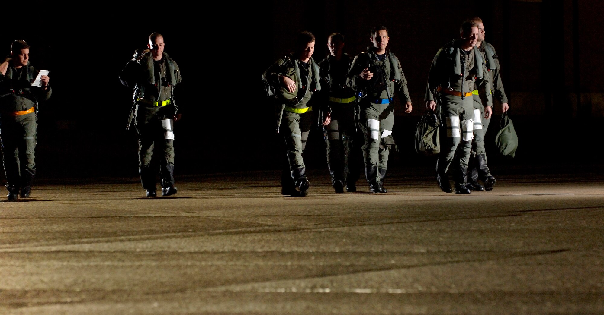 LANGLEY AIR FORCE BASE, Va. (AFPN) -- F-22A Raptor pilots walk to their jets during the base's Phase 1 operational readiness exercise here Feb. 3.  The Phase 1 ORE is an evaluation of the base's ability to prepare and deploy personnel, equipment and support assets to a combat environment. (U.S. Air Force photo by Tech. Sgt. Ben Bloker)