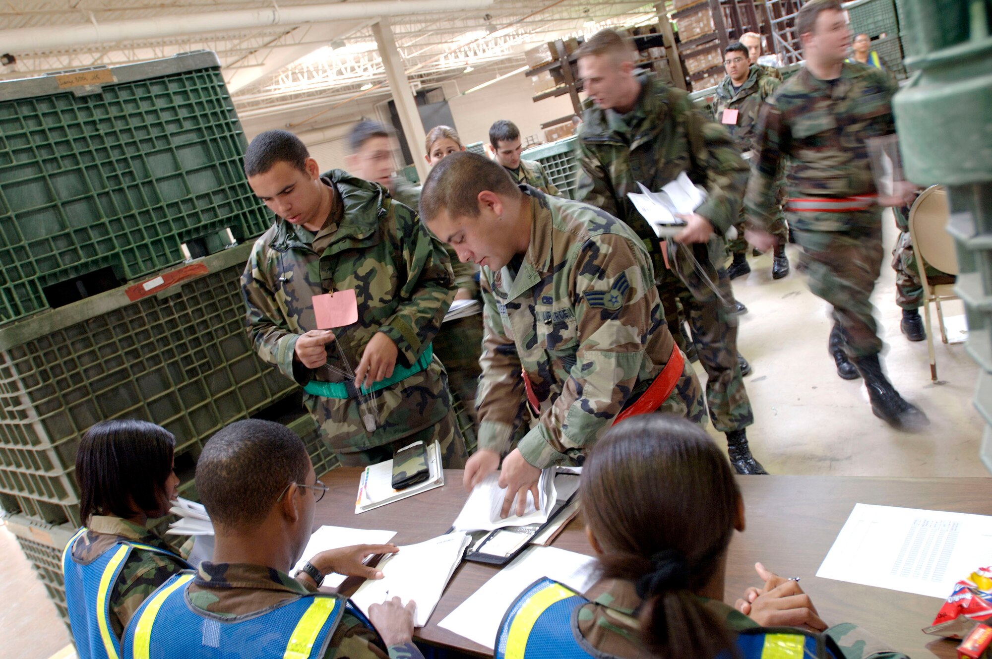LANGLEY AIR FORCE BASE, Va. (AFPN) -- Airmen process through the deployment eligibility desk during a Phase 1 operational readiness exercise here Feb. 1. The Phase 1 ORE is an evaluation of the base's ability to prepare and deploy personnel, equipment and support assets to a combat environment. The inspection consists of four graded areas: initial response and deployment, employment, ability to survive and operate, and combat response. (U.S. Air Force photo by Staff Sgt. Eric T. Sheler)