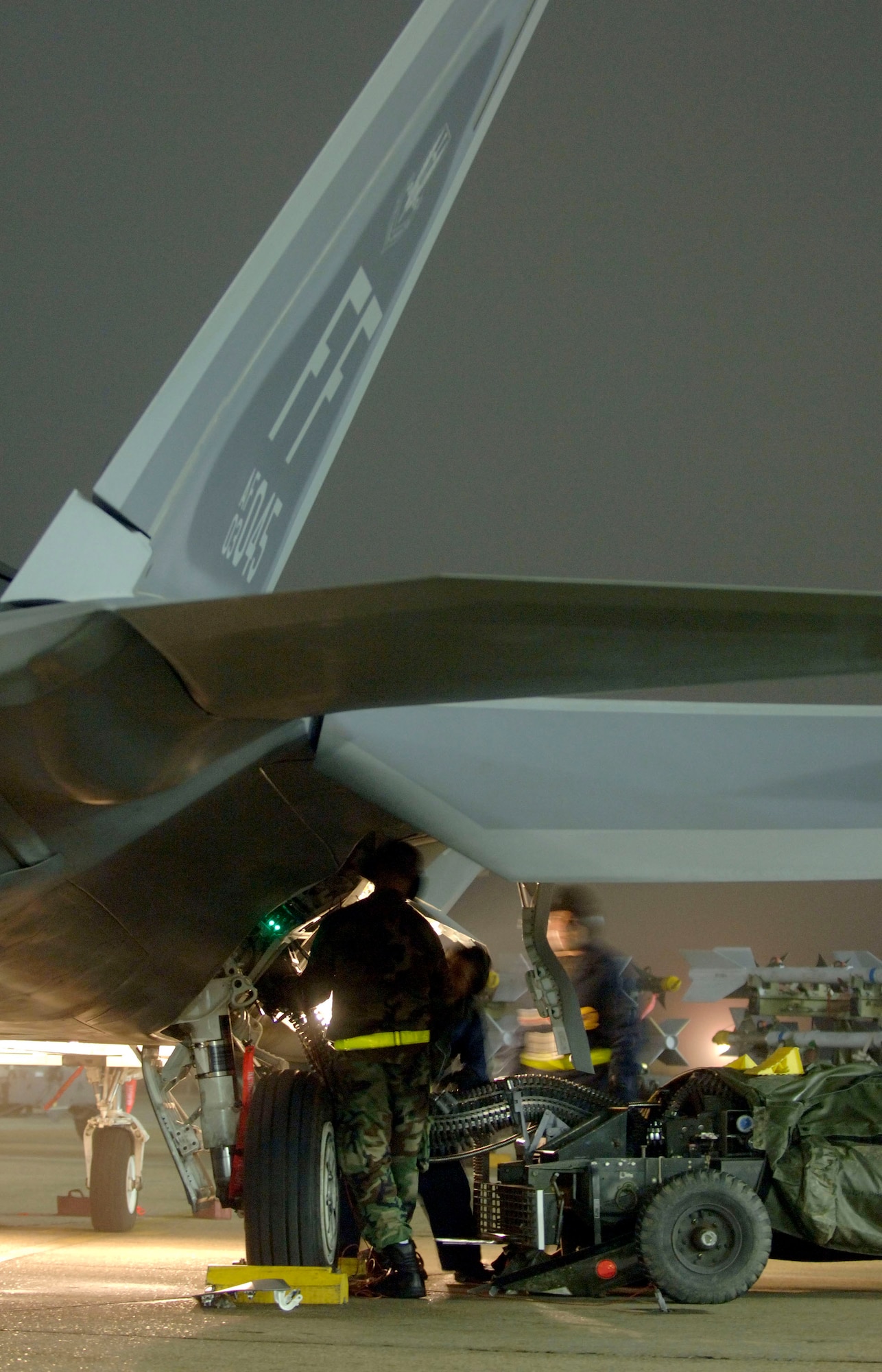 LANGLEY AIR FORCE BASE, Va. (AFPN) -- A weapons load team from the 27th Aircraft Maintenance Unit loads 20mm rounds on an F-22A Raptor during a Phase 1 operational readiness exercise here Jan. 31.  Weapons loaders are practicing load configurations to assess the time it takes to fully load the aircraft.  The Phase 1 ORE is an evaluation of the base's ability to prepare and deploy personnel, equipment and support assets to a combat environment. (U.S. Air Force photo by Tech. Sgt. Ben Bloker)