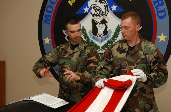 MOODY AIR FORCE BASE, Ga. - Staff Sgt. Michael Youngblood, 347th Maintenace Operations Squadron, trains Staff Sgt. Ben Wilson, 824th Security Forces Squadron, on how to perfect each move required to properly fold an U.S. flag Jan. 29 here. This flag is traditionally given to the next of kin by the NCO in charge of the ceremony.
(USAF Photo by SrA Angelita Collins)
                