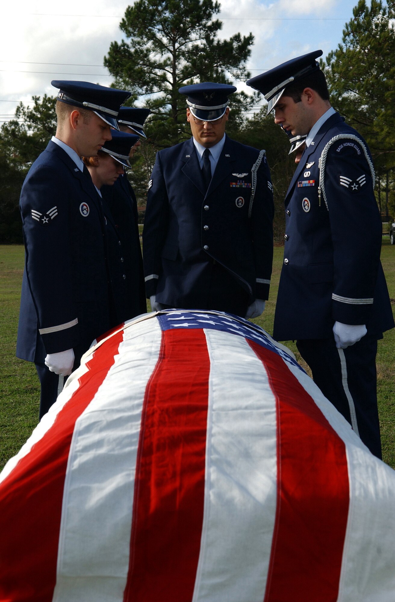 MOODY AIR FORCE BASE, Ga. - The Knights of Honor stand in quiet reverence before a flag-draped coffin Jan. 29 during a mock funeral here. During a real funeral, they would be posted behind the hurst preparing to pull the coffin out of the vehicle.  One person pulls the coffin out and walks backward with the coffin as the other five people grab the coffin and prepare to lift it off the hurst. 
(USAF Photo by SrA Angelita Collins)
                          