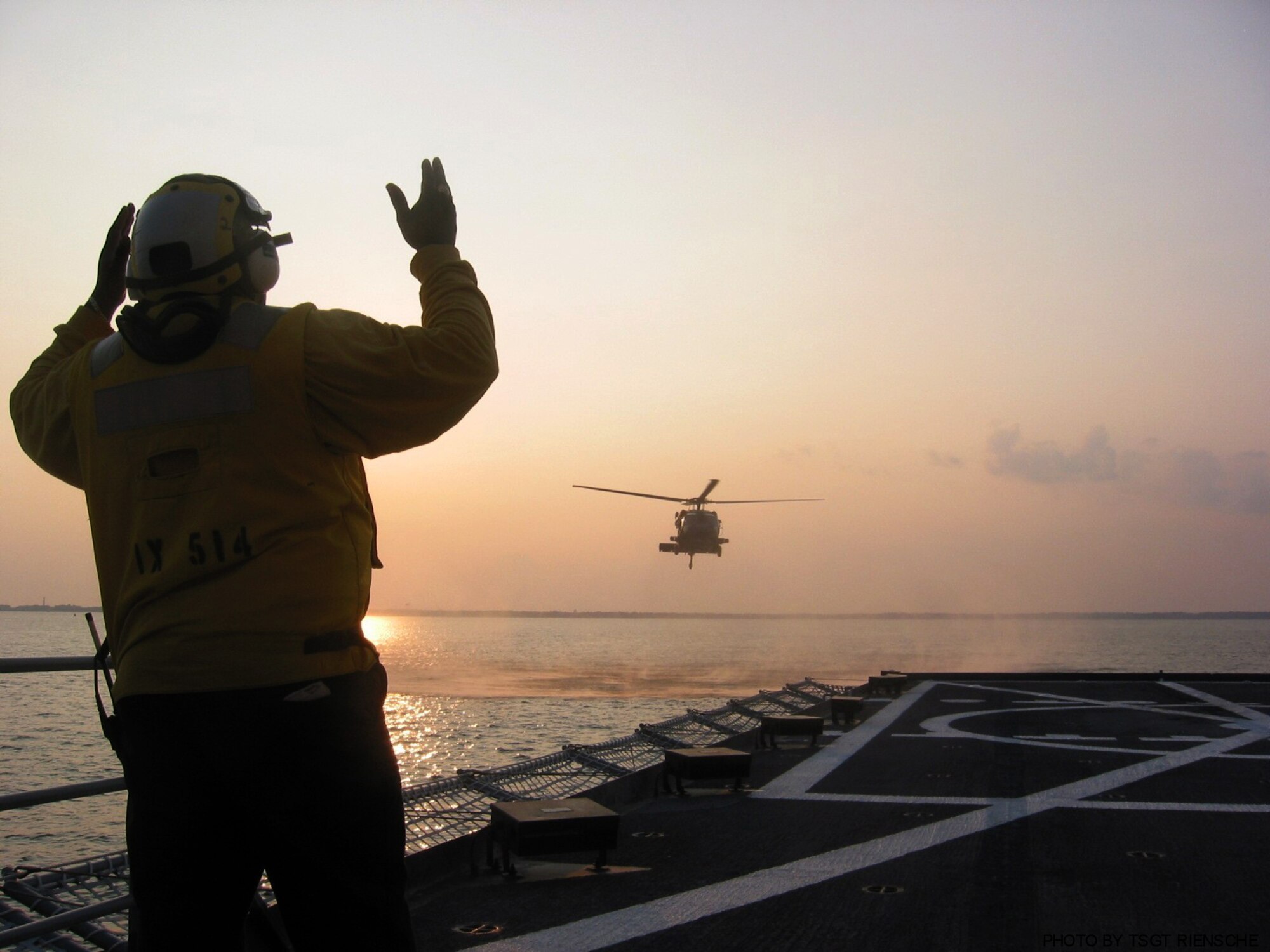 PENSACOLA BAY, Fla. - An HH-60G Pave Hawk, from the 41st Rescue Squadron at Moody Air Force Base, Ga., is guided into the Baylander, a Navy vessel used for helicopter training, during ship board operations Jan. 25 and 26 here. (Photo by Tech. Sgt. Mark Riensche)
