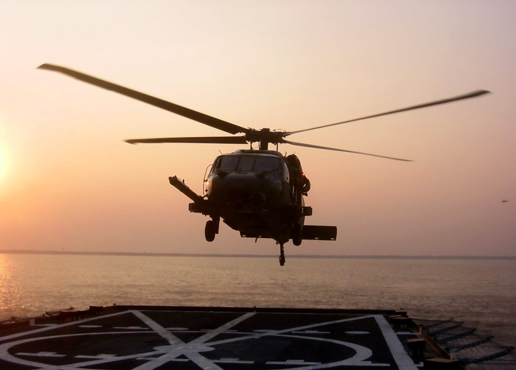 PENSACOLA BAY, Fla. - A 41st Rescue Squadron HH-60G Pave Hawk helicopter lands on the Baylander, a Navy vessel used for helicopter training, during ship boarding operations Jan. 25 and 26 at Pensacola Bay, Fla. The exercise is a mandatory training requirement for the 41st RQS, stationed at Moody Air Force Base, Ga., and improves its search and rescue capabilities. (Photo by Tech. Sgt. Mark Riensche)
