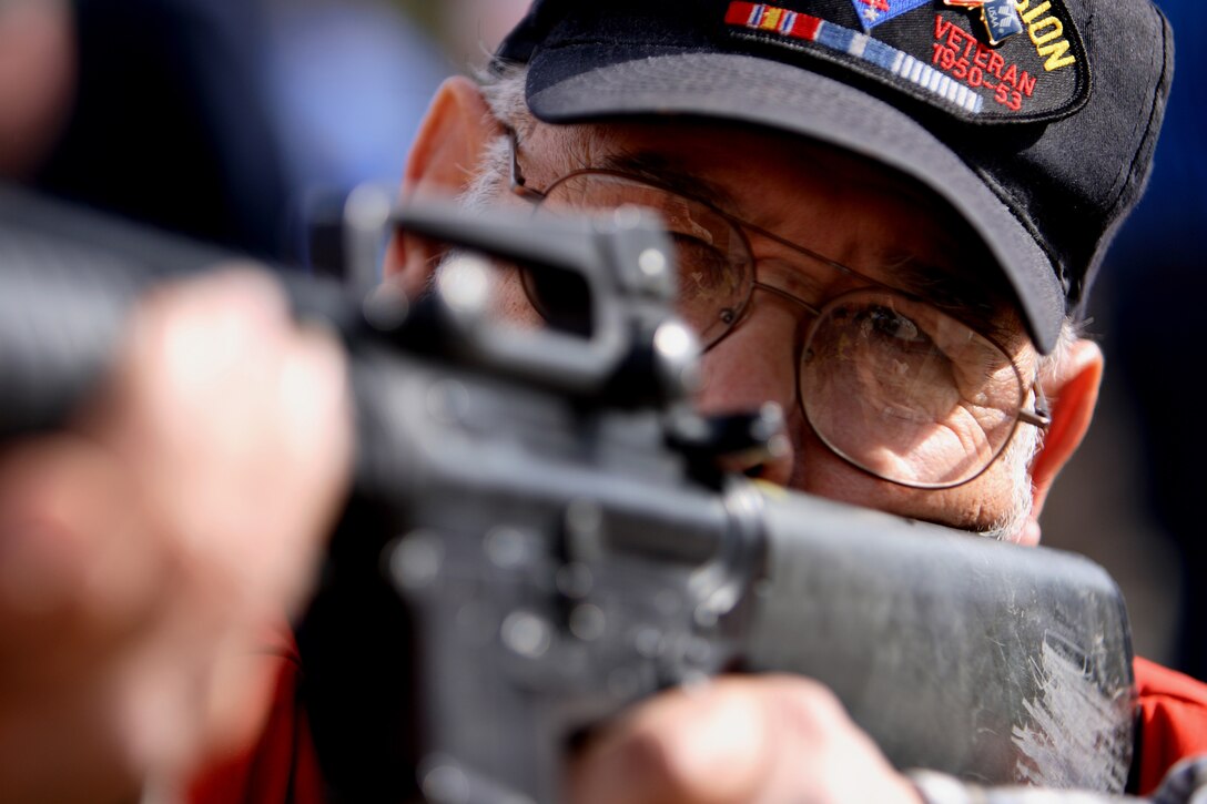Rick H. Salinas, 78, of San Jose, and a member of the 1st Marine Division Association, looks through the sight of an M-16 A4 and aims in on a target during a live-fire event at Camp Day Feb. 2. The event, which included a lunch of field rations, was hosted by 1st Battalion, 5th Marine Regiment and was a part of the 1st Marine Division's 65th anniversary celebrations