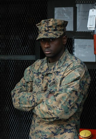 CAMP FALLUJAH, Iraq ? Sgt. Charley R. Smith stands still as another Marine reads off his reenlistment citation. Smith, as well as thousands of other Marines from 2nd Marine Logistics Group (Forward), deployed to Iraq in support of Operation Iraqi Freedom. Smith is an intelligence analyst with Combat Logistics Battalion-8, 2nd MLG (Fwd).