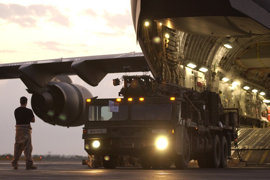 CAMP LEMONIER, Djibouti (AFPN) -- Senior Airman Jake Wyatt watches Soldiers load their well rig onto a C-17 Globemaster III aircraft. This year's $1.3 billion military construction request, as part of the president's fiscal year 2007 budget plan, is the largest in the last 15 years and includes projects for new mission beddowns for the C-17 Globemaster III. Airman Wyatt is a loadmaster from the 14th Airlift Squadron at Charleston Air Force Base, S.C.  (U.S. Air Force photo by Staff Sgt. Stephen Schester)