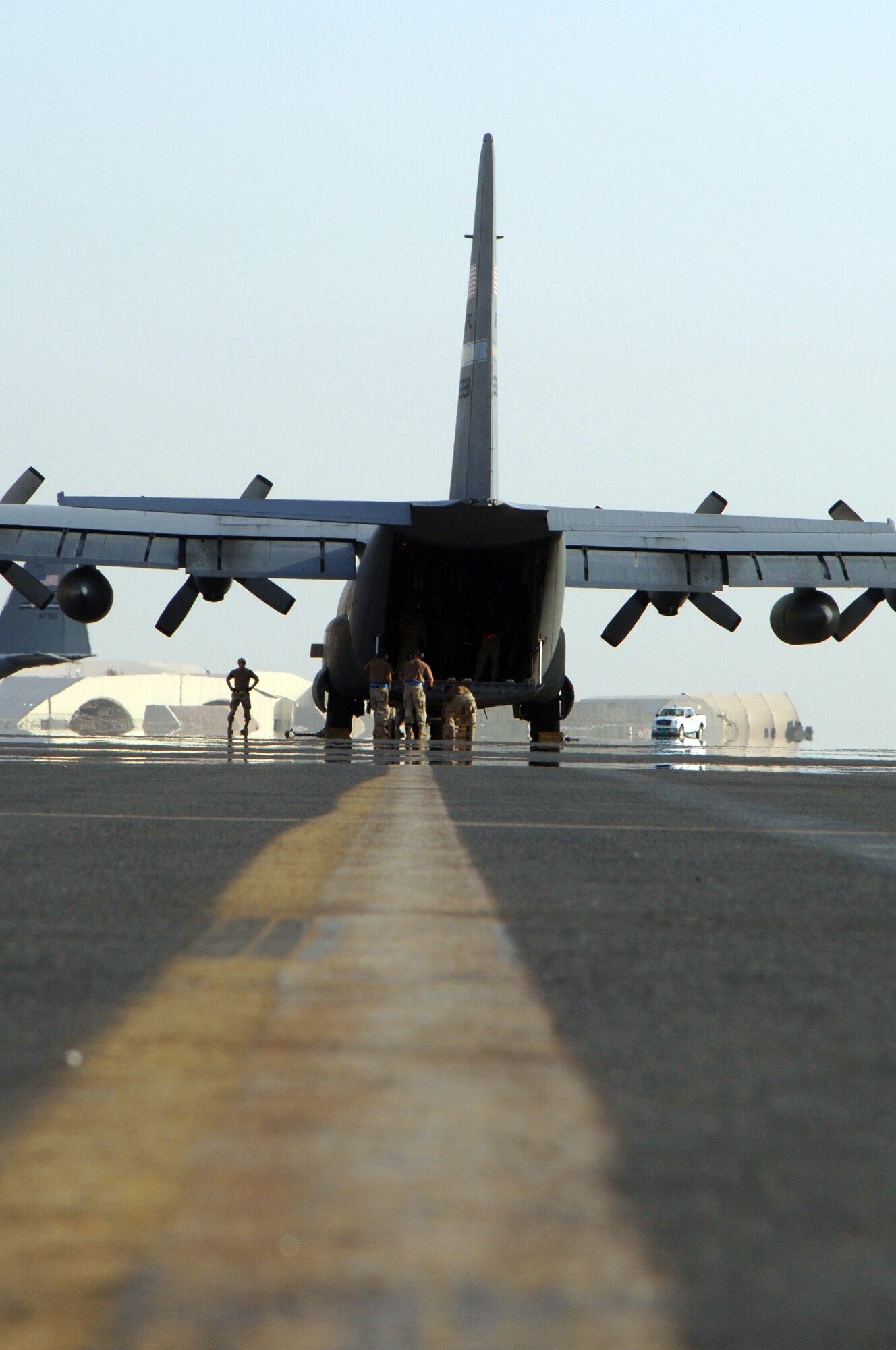 SOUTHWEST ASIA (AFPN) --- A C-130 Hercules from the Niagara Falls Joint Air Reserve Station in New York prepares to receive cargo at a deployed location Feb. 5.  (U.S. Air Force photo by Staff Sgt. Joshua Strang)