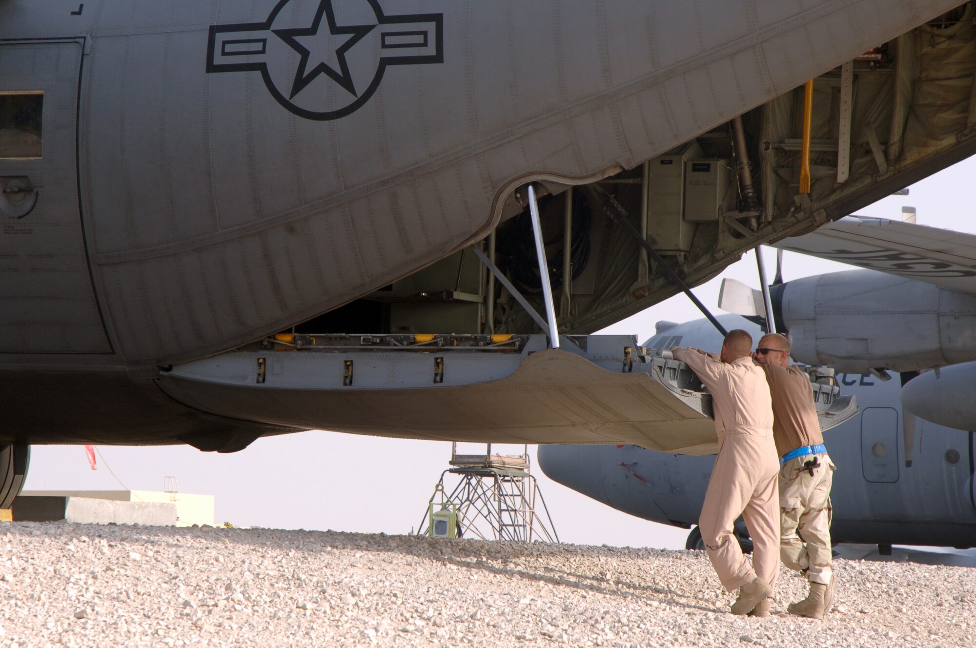 SOUTHWEST ASIA (AFPN) -- Two Airmen from the 746th Expeditionary Airlift Squadron wait while their C-130 Hercules is prepared for tow at a deployed location Feb. 5. The aircraft and crew are from the Niagara Falls Joint Air Reserve Station, N.Y. (U.S. Air Force photo by Staff Sgt. Joshua Strang)