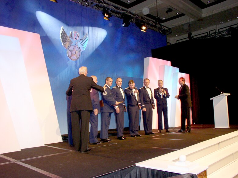 A mixed 920th Rescue Wing crew receives a standing ovation after Gen. Ronald E. Keys, commander of Air Combat Command, presents them with the Jimmy Doolittle Historical Fellow at the Buena Vista Palace Hotel in Orlando, Fla. Feb.3. From left to right:  Air Force Association gala chairman, Col. Tommy Harrison (Ret.); Technical Sgt Robert Grande, HC-130 Radio Operator; Technical Sgt. Ryan Renuart, HH-60 Pave Hawk aerial gunner; Master Sgt Chad Evans, Pararescuemen; 1Lt. Harley Doubet, Combat Rescue Officer; Maj. John Lowe, HH-60 Pave Hawk pilot; Lt. Col. Hugh Funk, HC-130 pilot; Gen. Ronald E. Keys, Commander of Air Combat Command; and AFA Central Florida Chapter President John T. 'Tim" Brock.   
