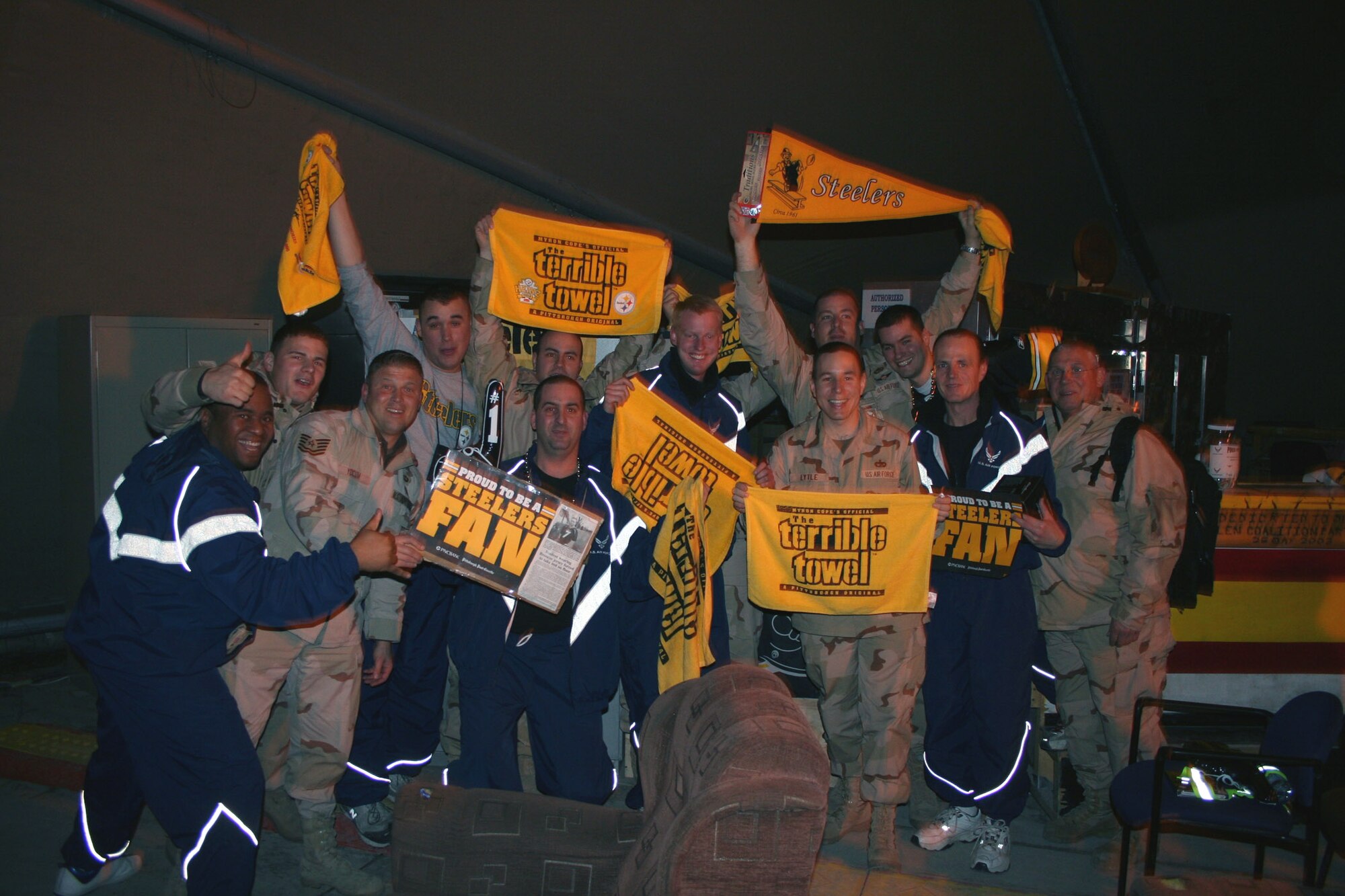 MANAS AIR BASE, Kyrgyzstan -- Deployed Reserve members from the 911th Airlift Wing, Pittsburgh Air Reserve Station, celebrate their team's victory as the loudspeakers boom "Pittsburgh's going to the Super Bowl!."  They packed their "Terrible Towels" before deploying in hopes that the Steelers would do well in the playoffs. Preparation paid off. The Steelers went on to win Super Bowl XL, 21-10, over the Seattle Seahawks. (U.S. Air Force photo by Staff Sgt. Laura Gale).
