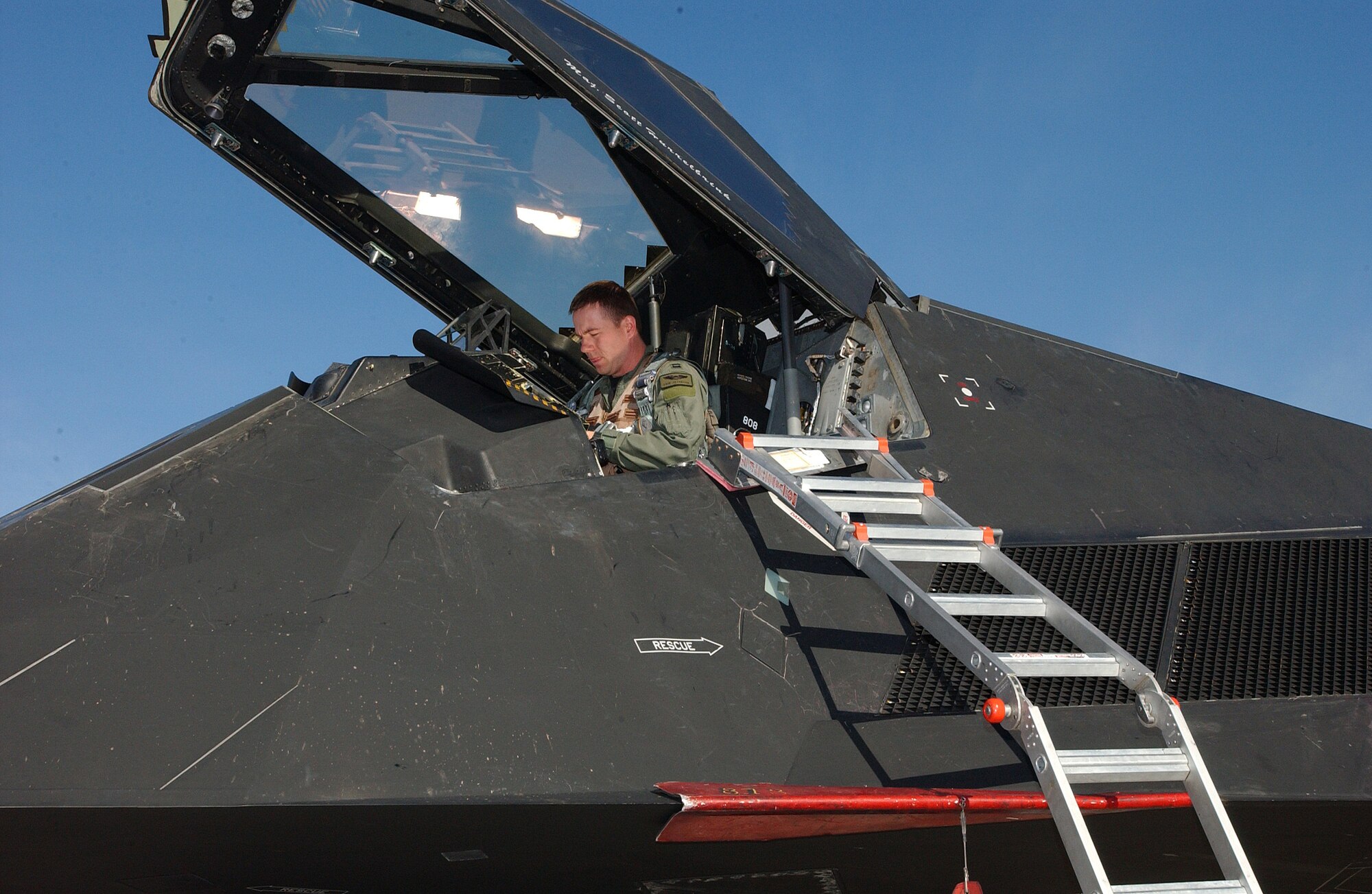 NELLIS AIR FORCE BASE, Nev. (AFPN) -- Capt. Erik Jacobson reads a pre-flight checklists during Red Flag 06-1, here Jan. 21 to Feb. 18. Red Flag is an exercise that tests aircrews' warfighting skills. Flights involve more than 100 aircraft, including B-52 Stratofortresses and F-16 Fighting Falcons. The aircraft are flying missions day and night to the nearby Nevada Test and Training Range where they simulate an air war. Along with the Air Force, units from the Army, Navy, NATO and several allied countries are participating. Captain Jacobson is an F-117A Nighthawk pilot with the 49th Fighter Squadron at Holloman Air Force Base, N.M.  (U.S. Air Force photo by Staff Sgt. Kenny Kennemer)