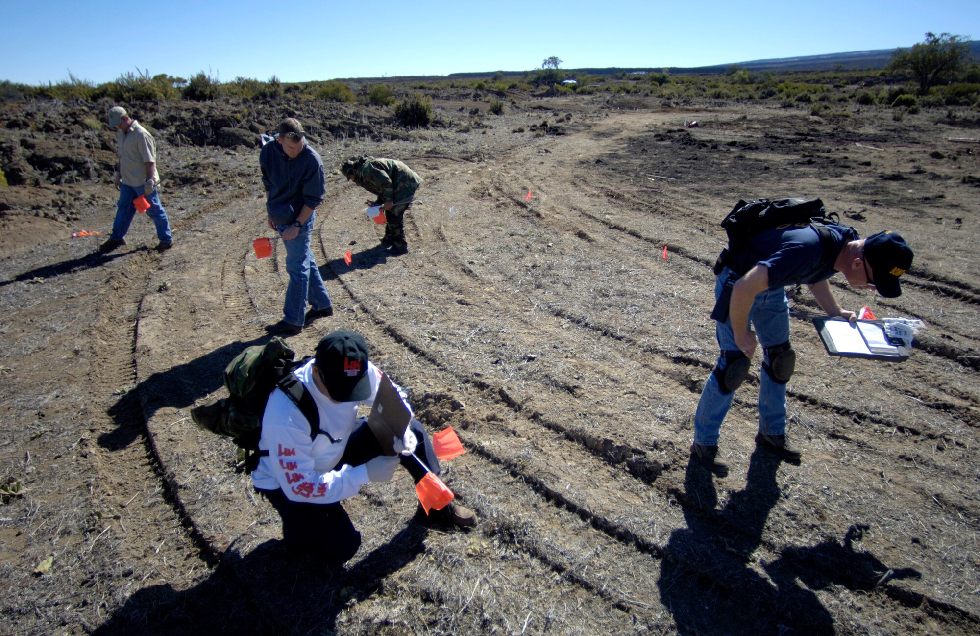 POHAKULOA TRAINING AREA, Hawaii (AFPN) -- Students search for and mark evidence at a bomb scene scenario. The FBI, along with Army cadre, conducted a large vehicle post blast investigator's course here. It included instruction on investigative techniques and evidence collection. (U.S. Air Force photo by Tech. Sgt. Shane A. Cuomo) 