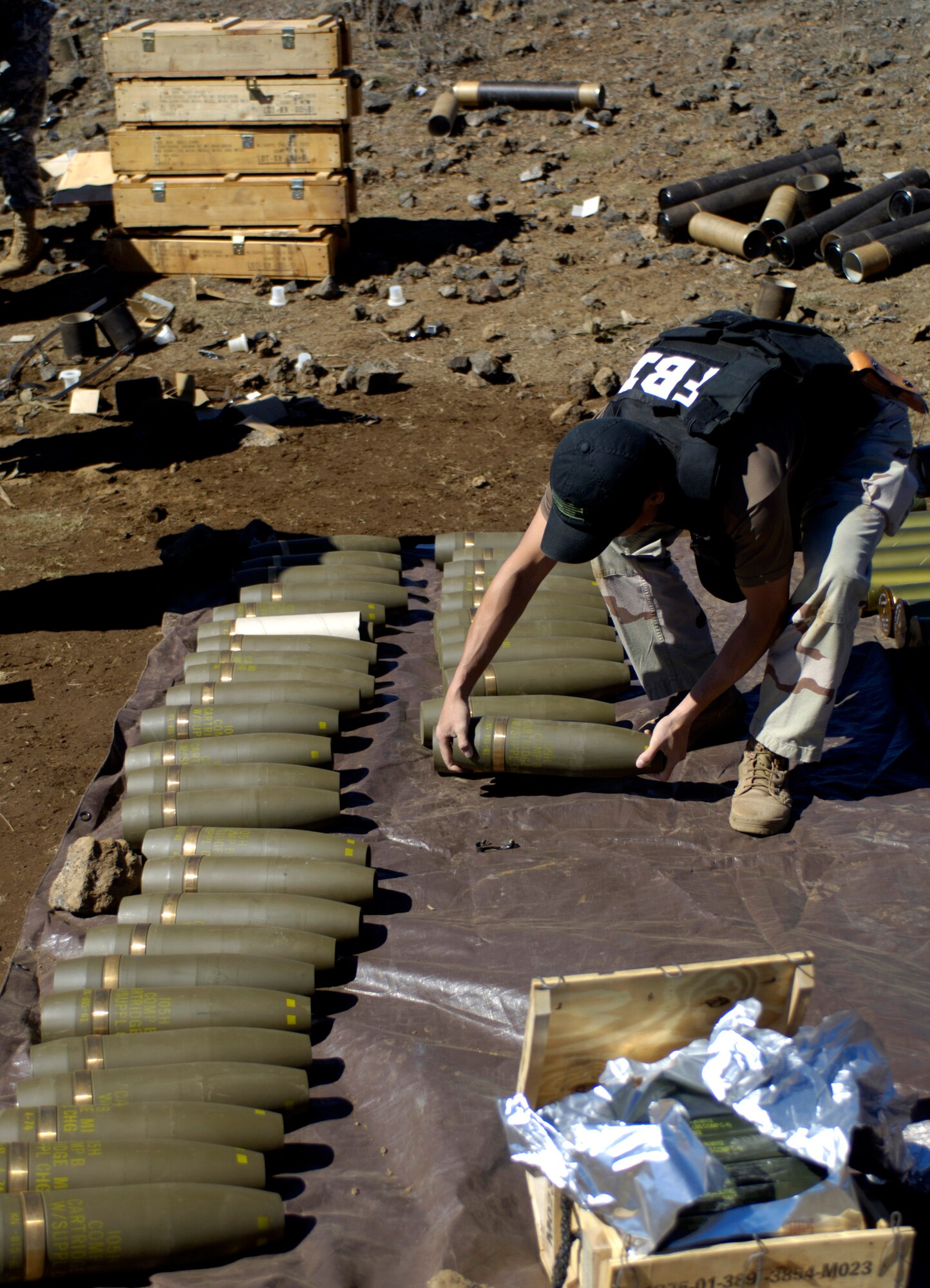 POHAKULOA TRAINING AREA, Hawaii (AFPN) -- FBI Special Agent Sam Mum lines up 105 mm rounds for a vehicle-borne explosive device scenario. The FBI, along with Army cadre, conducted a large vehicle post blast investigator's course here. It included instruction on investigative techniques and evidence collection. (U.S. Air Force photo by Tech. Sgt. Shane A. Cuomo)