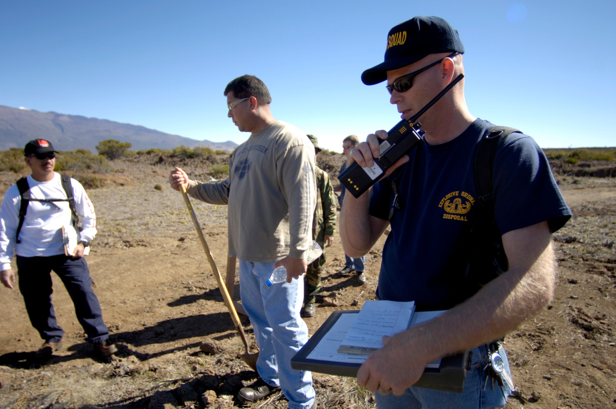 POHAKULOA TRAINING AREA, Hawaii (AFPN) -- Master Sgt. James Skyberg contacts the command post before leading his team into a bomb scene scenario. The FBI, along with Army cadre, conducted a large vehicle post blast investigator's course here. It included instruction on investigative techniques and evidence collection. Sergeant Skyberg is with the 15th Civil Engineer Squadron explosive ordinance disposal flight at Hickam Air Force Base, Hawaii. (U.S. Air Force photo by Tech. Sgt. Shane A. Cuomo) 
