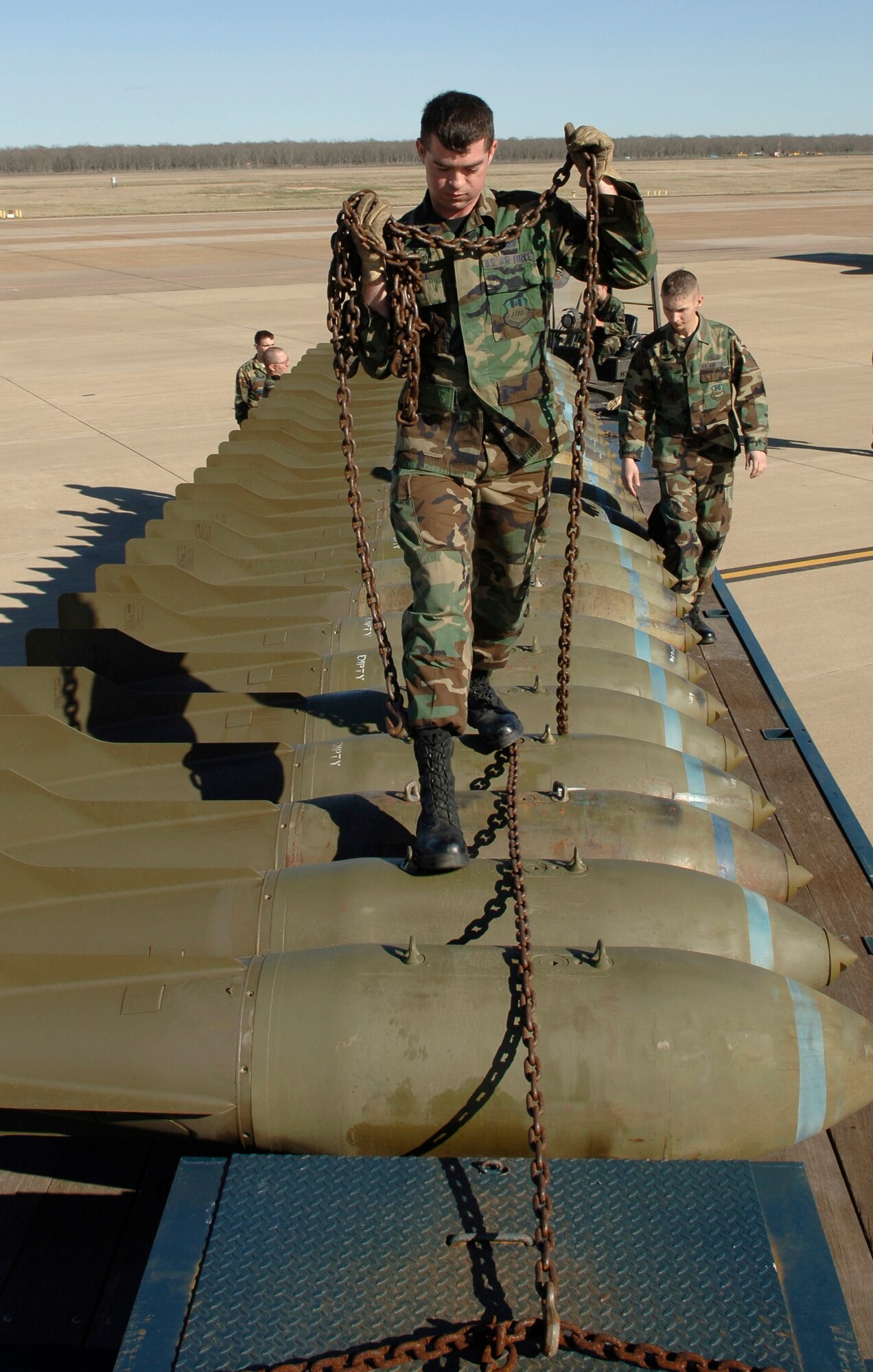 BARKSDALE AIR FORCE BASE, La. (AFPN) -- Airman 1st Class Kevin J. Penwell prepares M-117 bombs for unloading.  The munitions are set up for display with the B-52 Stratofortress to show its full capabilities. Airman Penwell is with the 2nd Munitions Squadron here. (U.S. Air Force photo by Tech. Sgt. Robert J. Horstman)