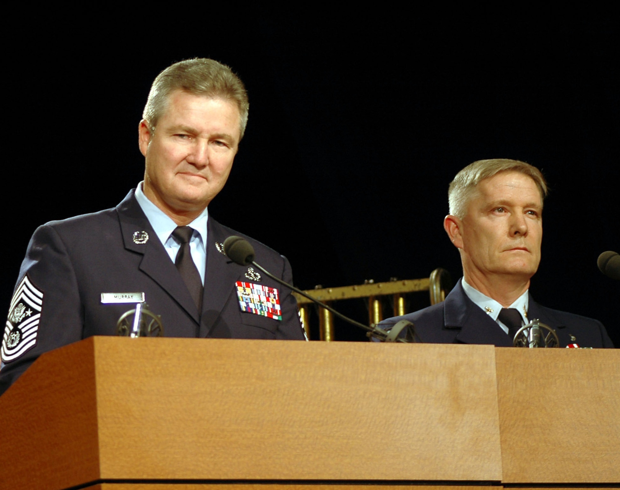 WASHINGTON (AFPN) -- Chief Master Sergeant of the Air Force Gerald R. Murray and U.S. Coast Guard Master Chief Petty Officer Jeffrey D. Smith narrate selections between musical acts during a tribute to America's armed forces here Feb. 6. Entertainers, musicians, journalists and senior military leaders gathered at the Pentagon auditorium for the two-hour event, titled "For the Love of America -- A Musical Love Letter to the Troops." Musical talent was provided by the Veterans Administration National Medical Chorale and Symphony Orchestra. (U.S. Air Force photo by Staff Sgt. C. Todd Lopez)