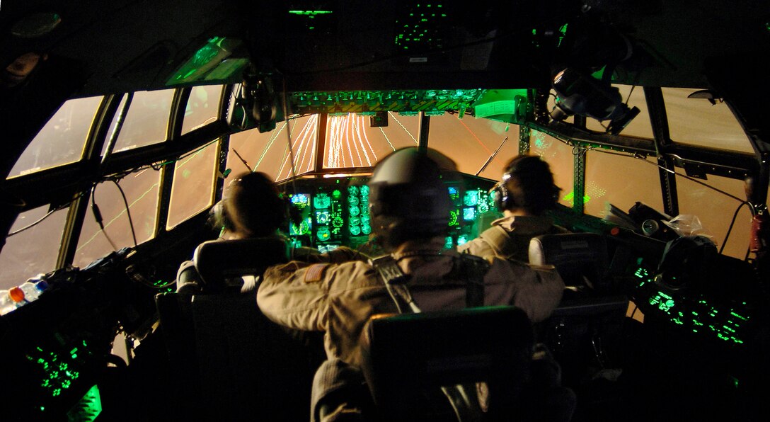 SOUTHWEST ASIA -- Maj. John Eric Hall, Tech. Sgt. Craig Schueller and Capt. Tim Pemberton approach a runway in a C-130 Hercules after a combat support mission. The Reservists are with the 746th Expeditionary Airlift Squadron. (U.S. Air Force photo by Master Sgt. Lance Cheung)