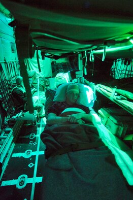 BALAD AIR BASE, Iraq (AFPN) -- Army Sgt. Jamie Hughes of the 101st Airborne Division relaxes during a flight out of Iraq on a C-130 Hercules. Critical care air transport teams set up air evacuation litter racks and patient care kits so patients can have safe and comfortable flights. (U.S. Air Force photo by Master Sgt. Lance Cheung)