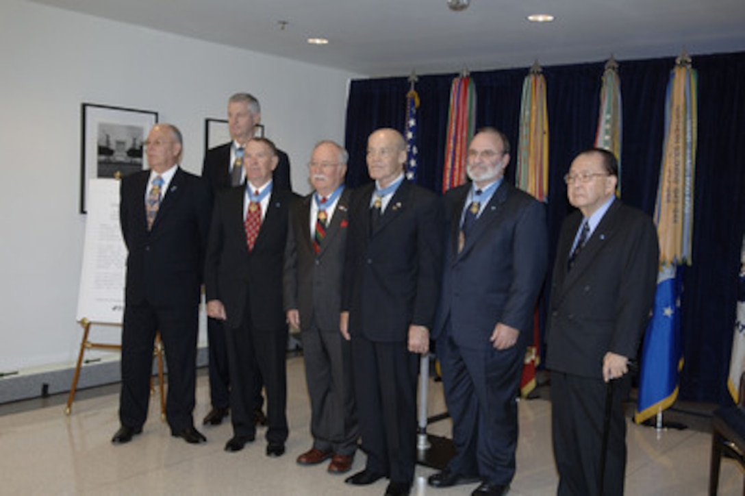 Seven Congressional Medal of Honor recipients pose for photos after a ceremony opening the Visions of Valor display in the Pentagon on Feb. 3, 2006. Attending the ceremony are from left to right Gary L. Littrell, U.S. Army, Robert F. Foley, U.S. Army, Walter J. Marm Jr., U.S. Army, Harvey C. "Barney" Barnum, Jr., U.S. Marine Corps, Robert L. Howard, U.S. Army, Brian M. Thacker, U.S. Army, and Senator Daniel K. Inouye, U.S. Army. Deputy Secretary of Defense Gordon England hosted the ceremony and was joined by President of the Congressional Medal of Honor Society Gary Littrell and Tri-West Healthcare Alliance President and CEO David McIntyre. Tri-West Healthcare Alliance commissioned two sets of the photographs by Nick DelCalzo that depict 116 of the recipients of the Congressional Medal of Honor. One set was donated for permanent display in the Pentagon and the other will comprise a traveling exhibit to be shown nationally. 